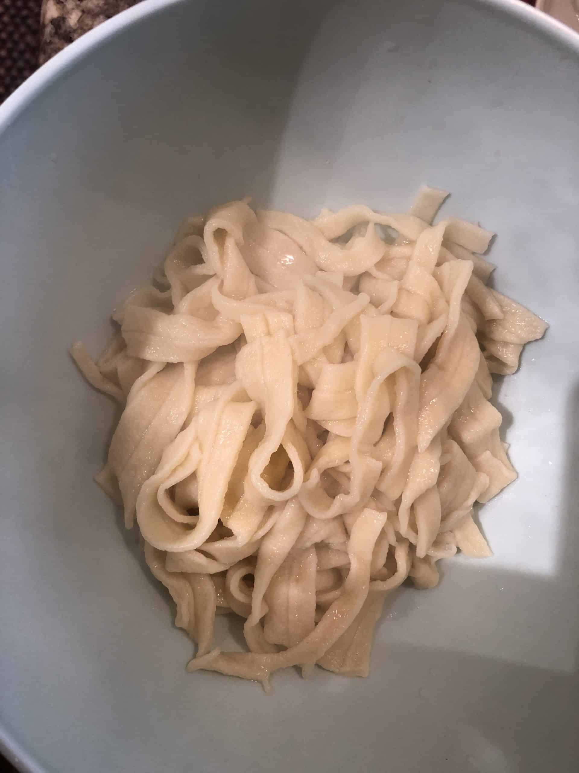 Strain cooked noodles in cold water.