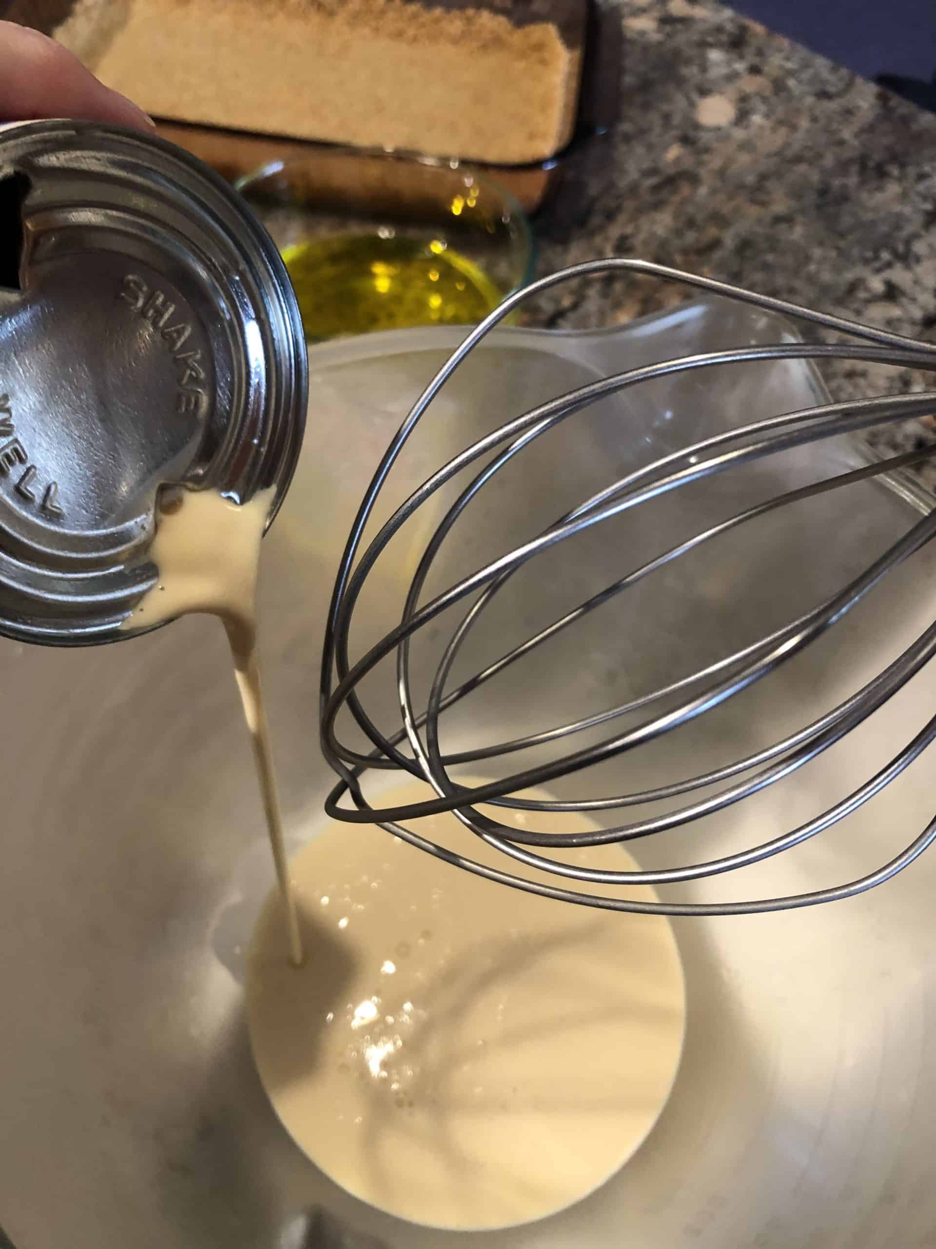 Pouring Evaporated Milk into the Chilled Mixing Bowl