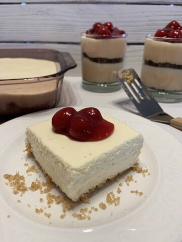 Citrus No-Bake Cheesecake on a plate with Cherry Topping