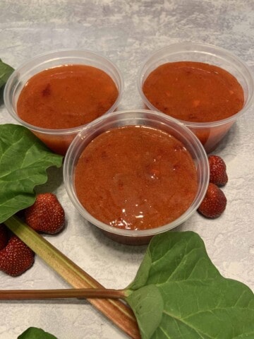 3 Strawberry Rhubarb Jam (freezer) containers with fresh rhubarb and strawberries