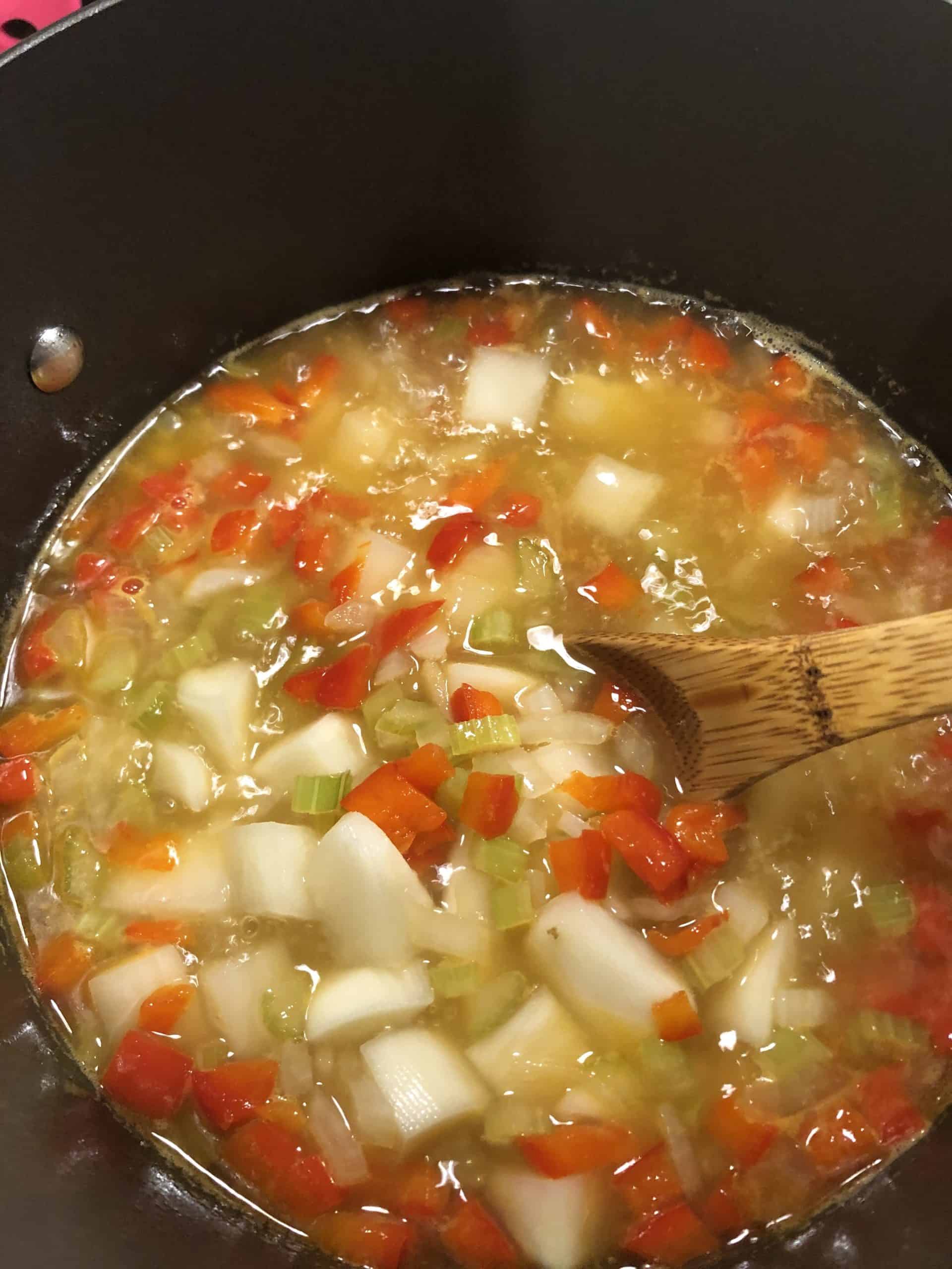 Chicken Stock, Diced Red Peppers, Onions, and Celery in a stock pot