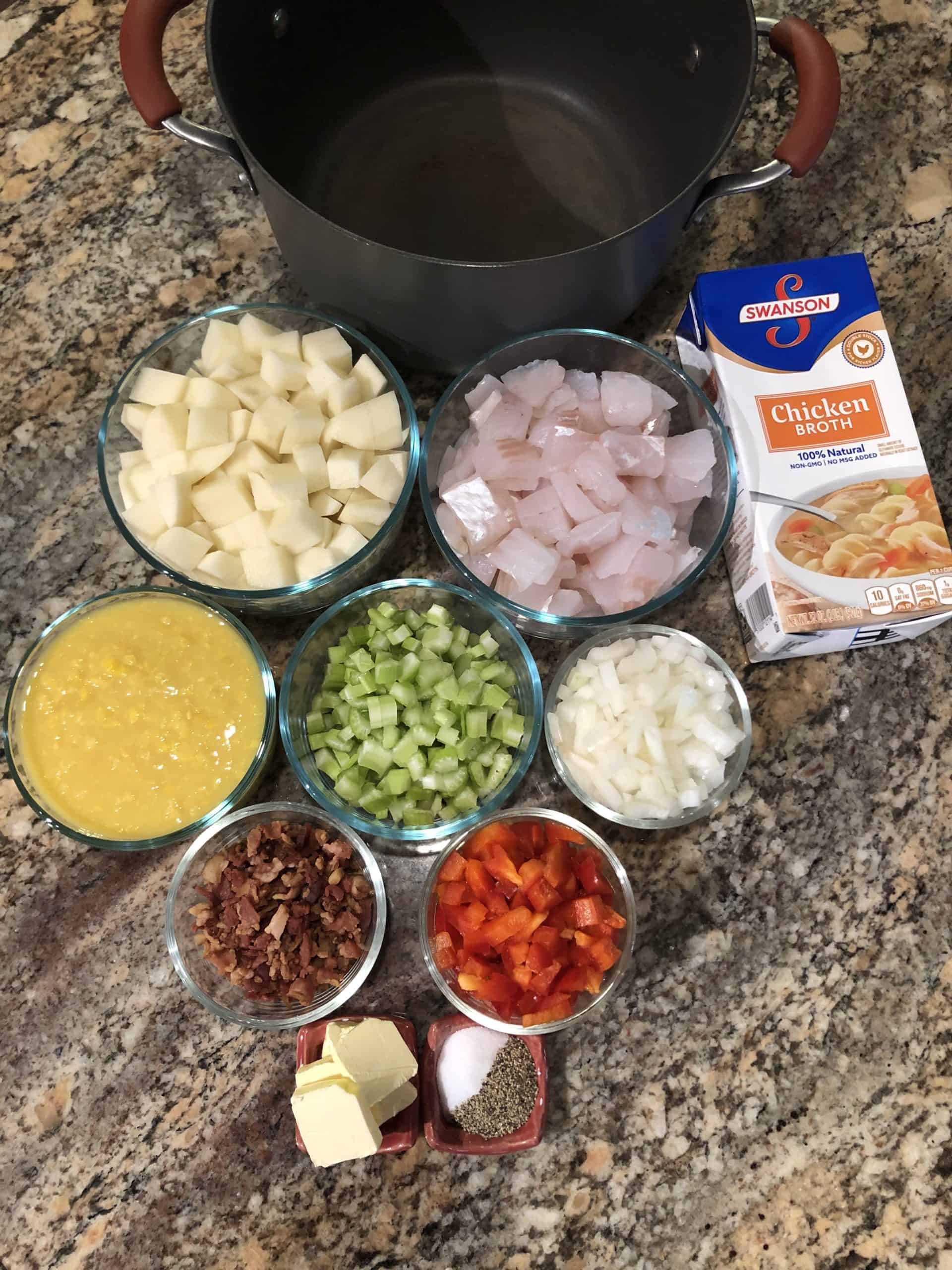 Fish Chowder ingredients - red peppers, celery, onions, potatoes, bacon bits, creamed corn, butter, salt and pepper, chicken stock, fish and large stock pot