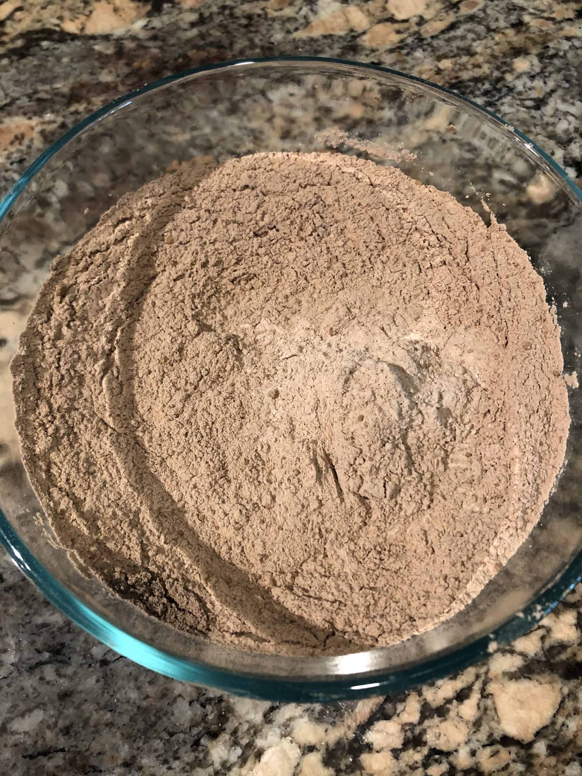 Mixed dry ingredients in a bowl - flour, salt, cinnamon, baking soda, baking powder and cocoa powder