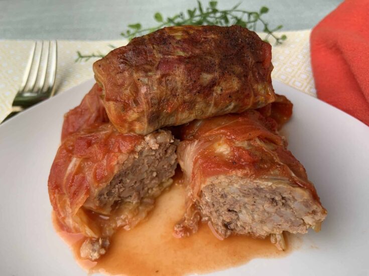 Cabbage Rolls on a plate cut in half.