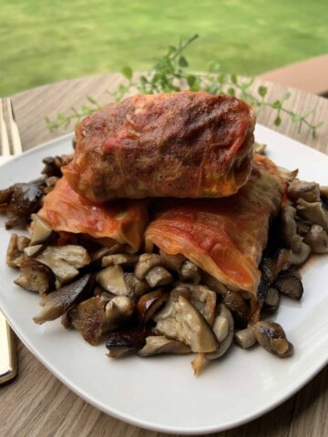 Cabbage Rolls with stump mushrooms on a plate.