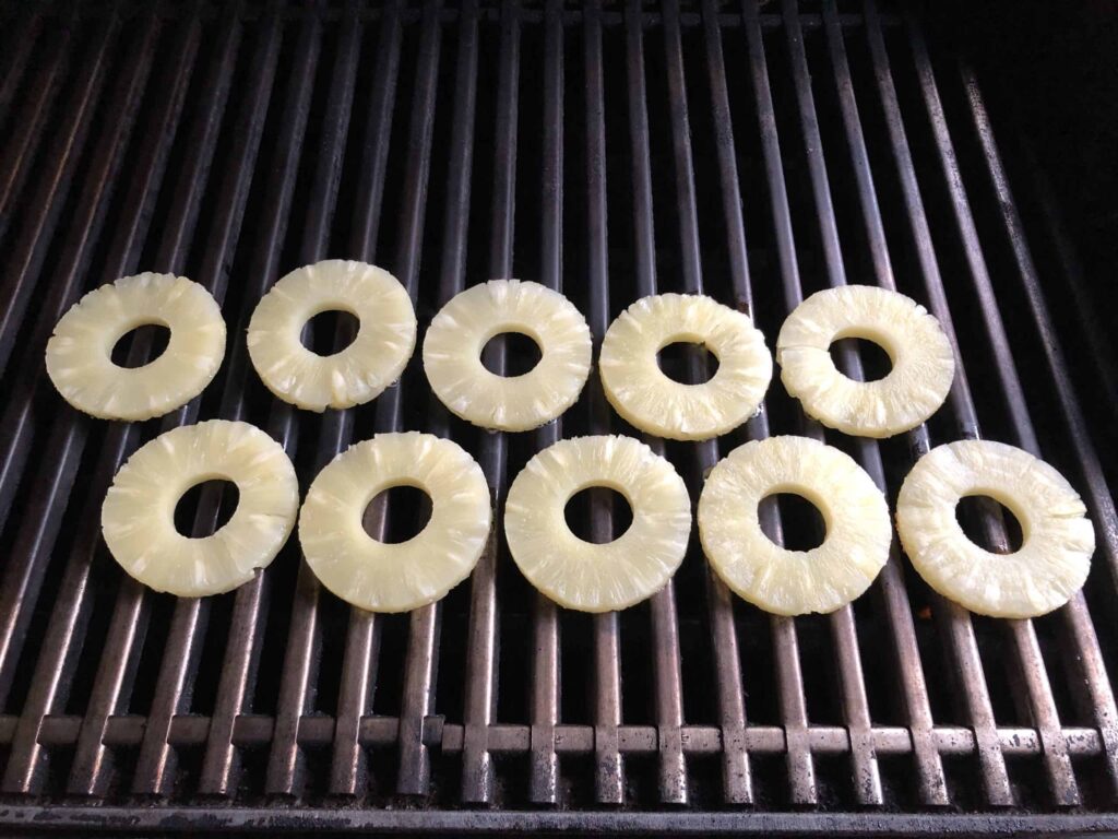Pineapple rings on a grill.
