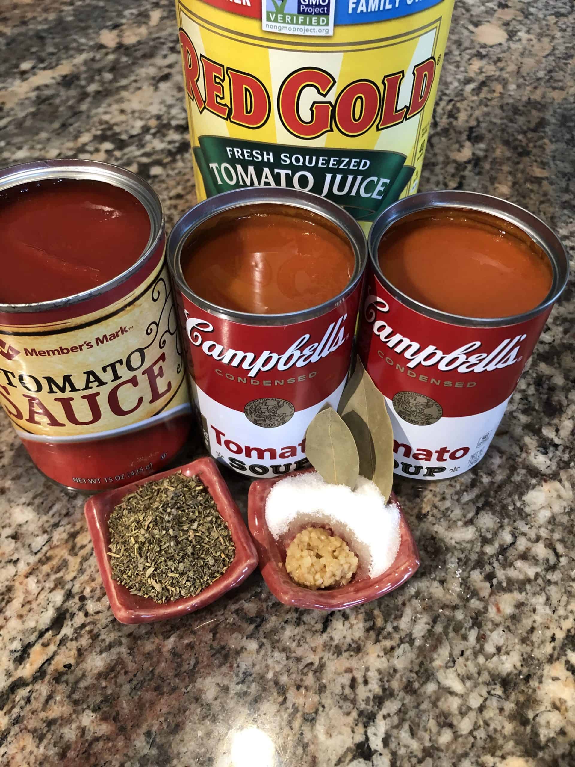 Spaghetti Sauce ingredients - tomato juice, sauce, and soup, diced onion, hamburger, Italian seasoning, bay leaves, garlic, and sugar. 
