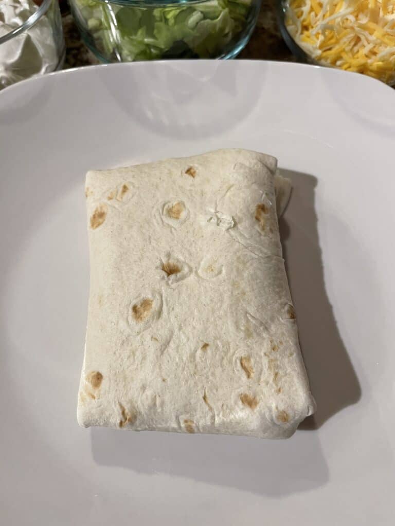 Fold in the ends and flip over your burrito.