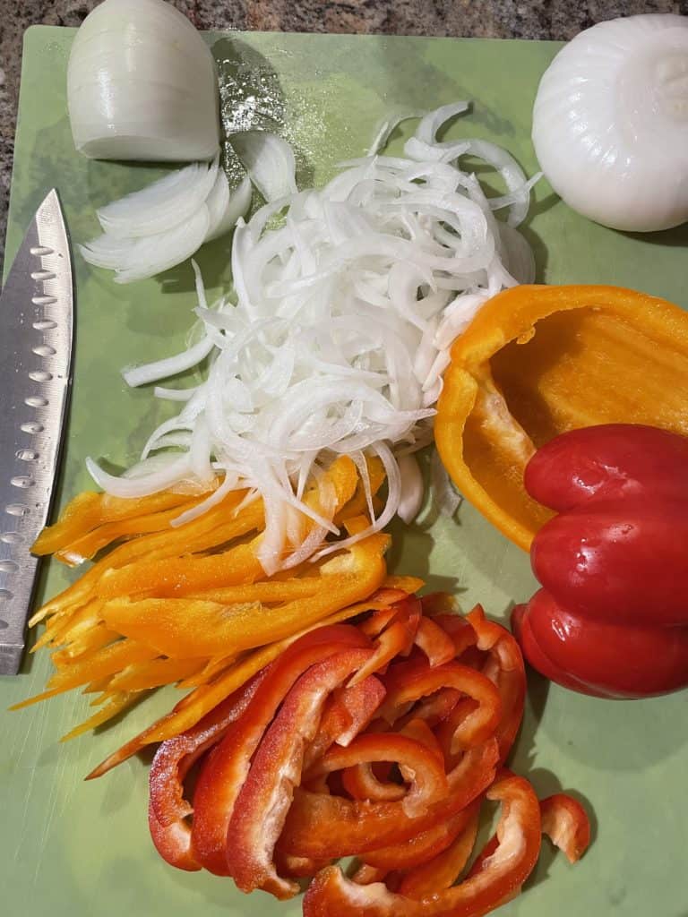 Slice Onion and Peppers In Thin Strips.