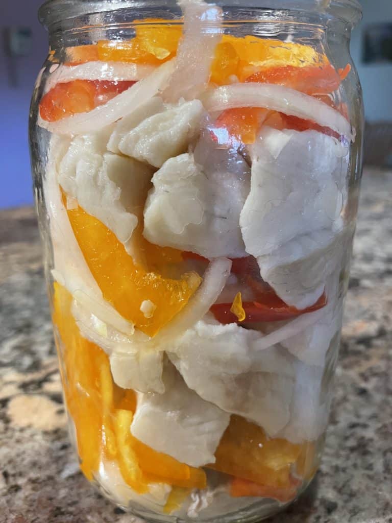 Pack the Rinsed Pike Pieces, Sliced Onion and Peppers in Layers Until the Jar is Completely Full.