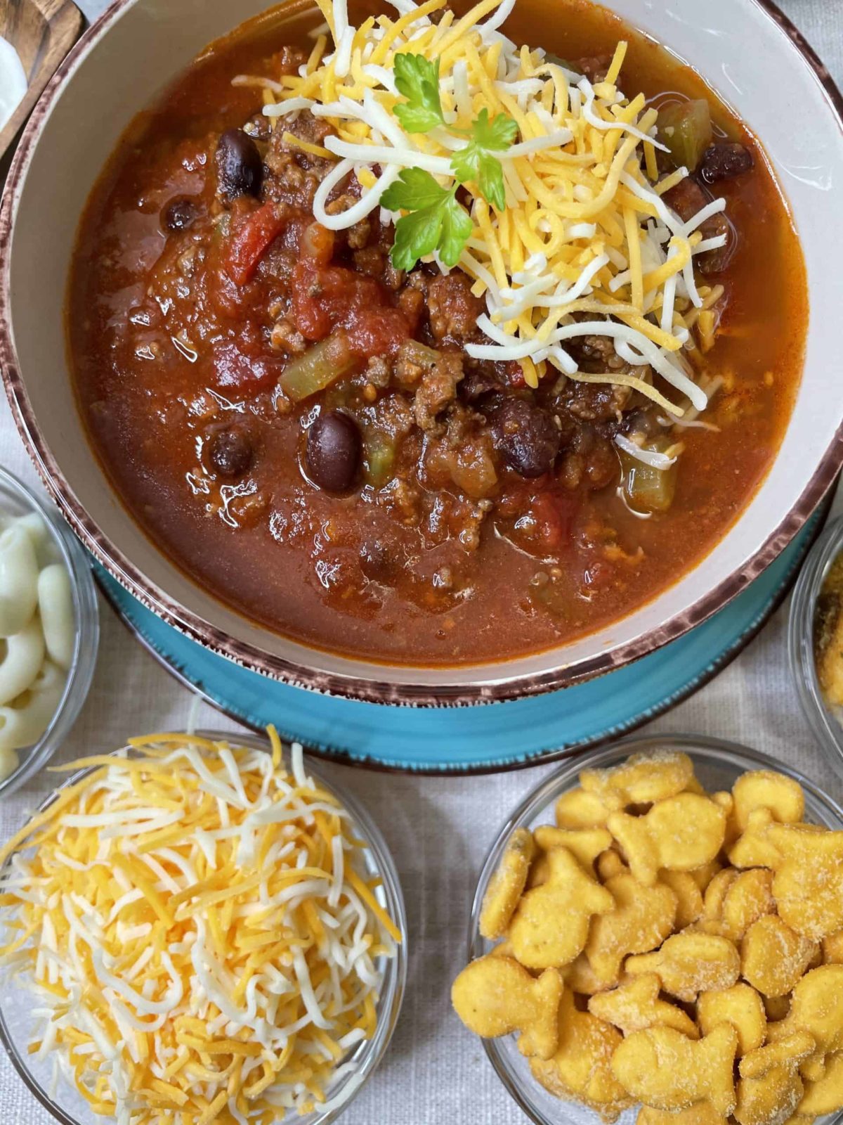 Black Bean Chili with Shredded Cheese, Gold fish, and Cooked Noodles.