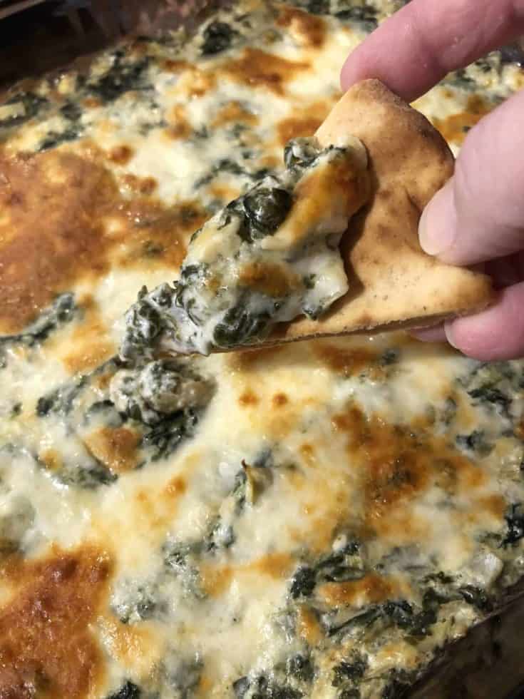 Pita bread dipped in Baked Spinach Artichoke Dip