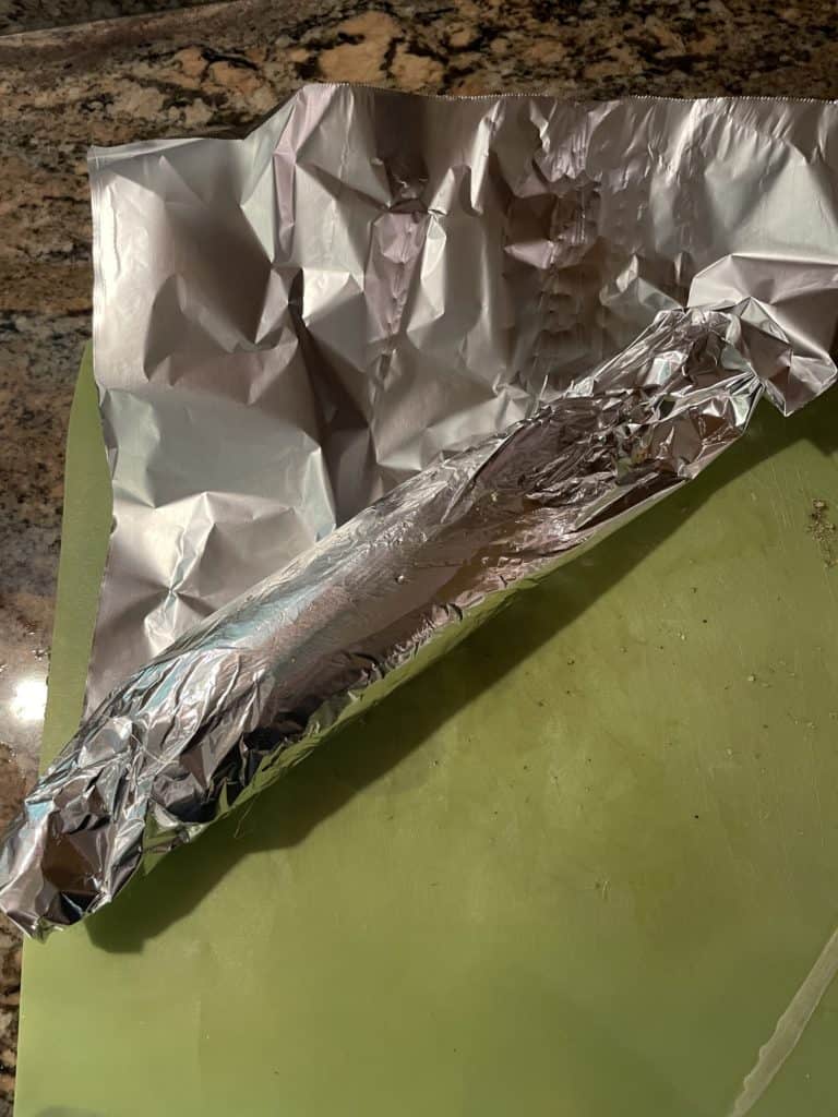Fold in the bottom of the foil onto the corn cob.