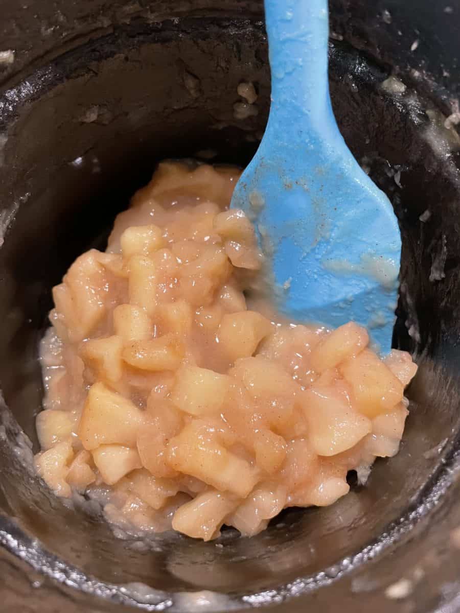 Cooked apple fritter filling in a pan.