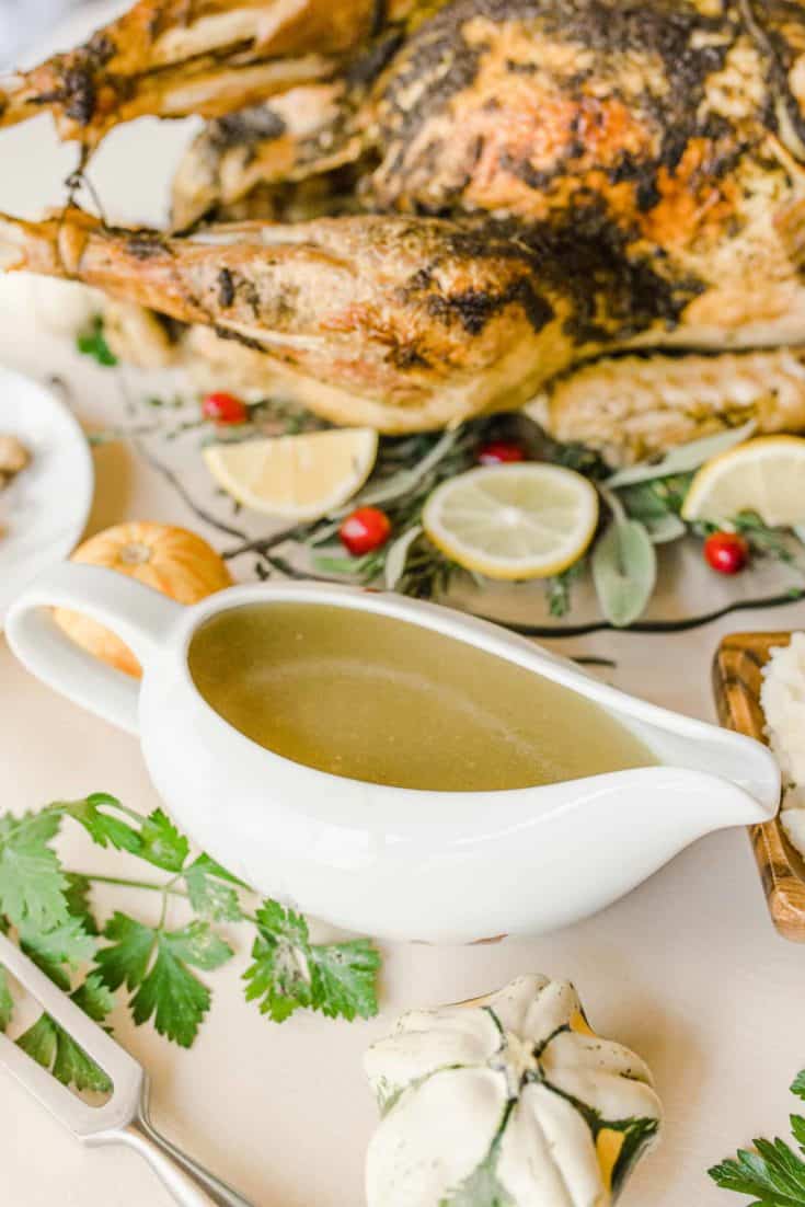 Quick and Easy Gluten Free Turkey Gravy with Pesto on a Thanksgiving table with turkey.