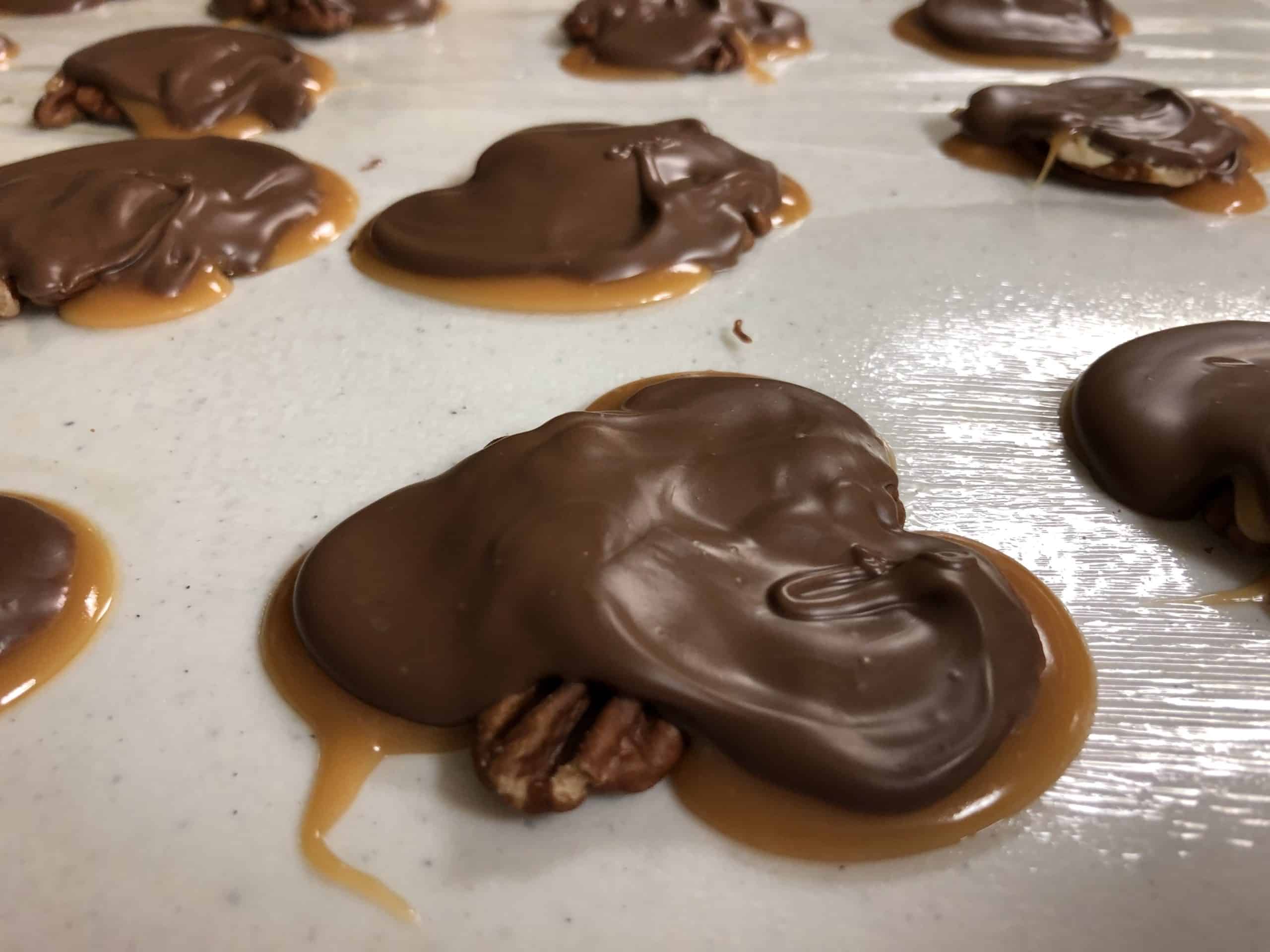 Homemade chocolate, caramel, and pecan turtles.