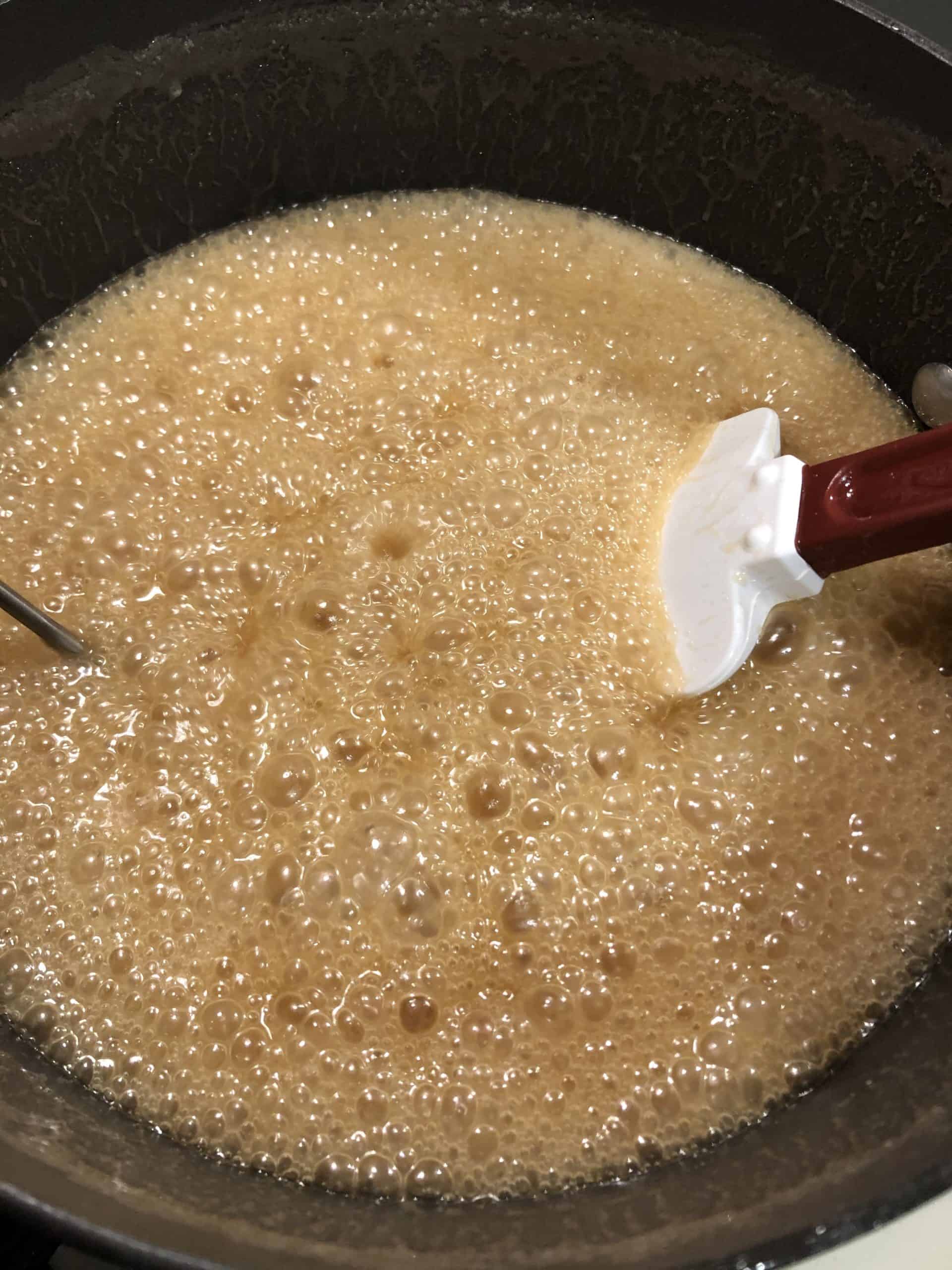 First stage of making homemade caramel in a 6 quart saucepan.