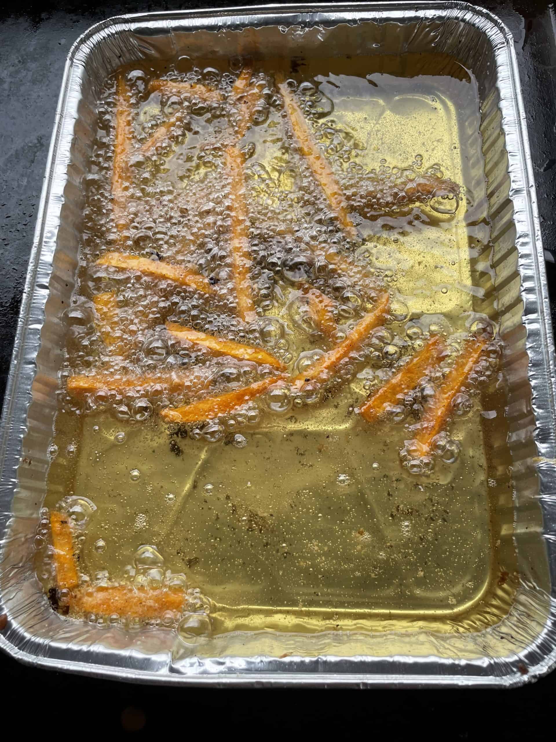 Fry Sweet Potato Fries in a pan of hot oil on a Blackstone Griddle.