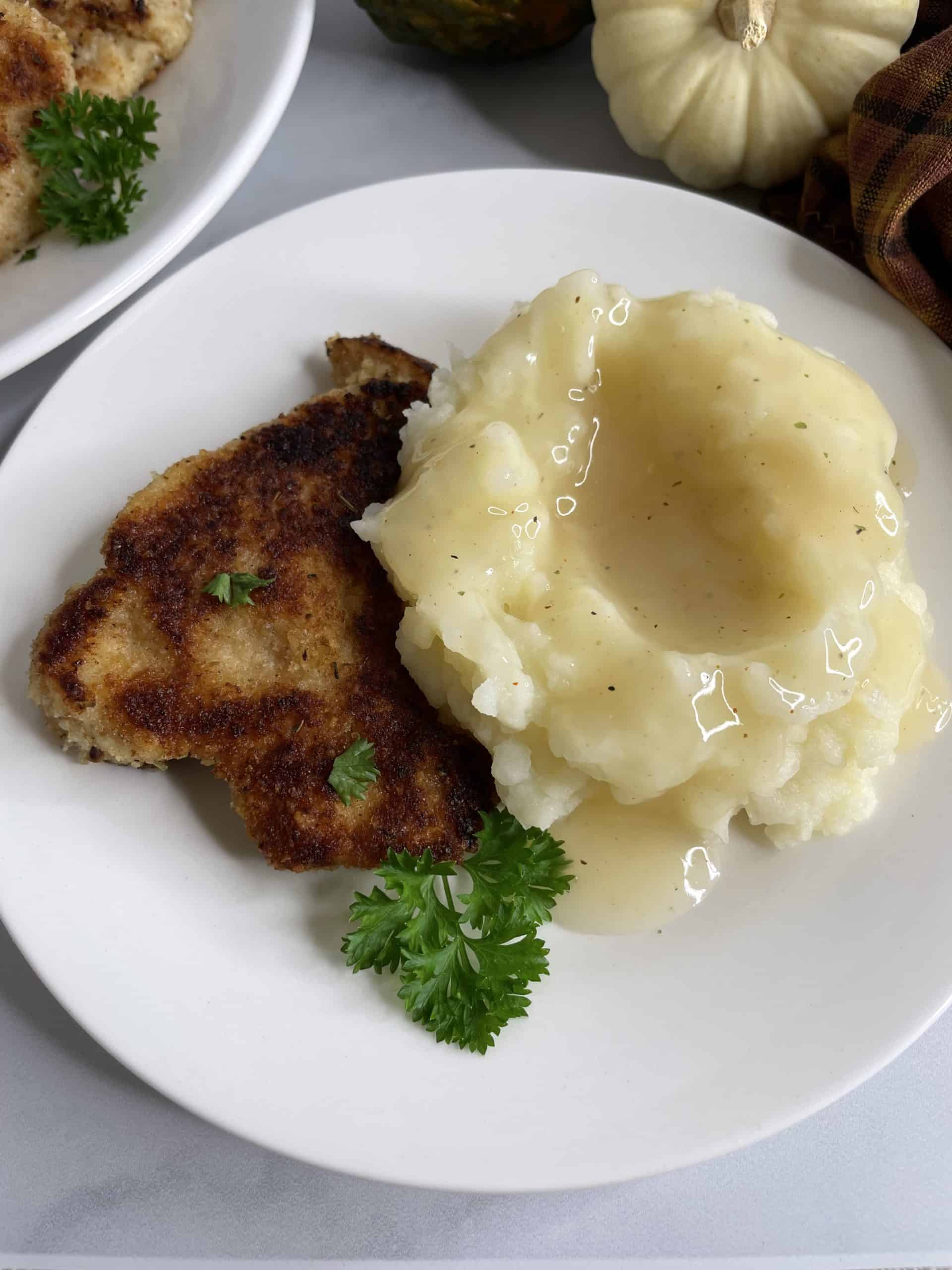 Turkey Cutlets Recipe with mashed potatoes and gravy on a plate.