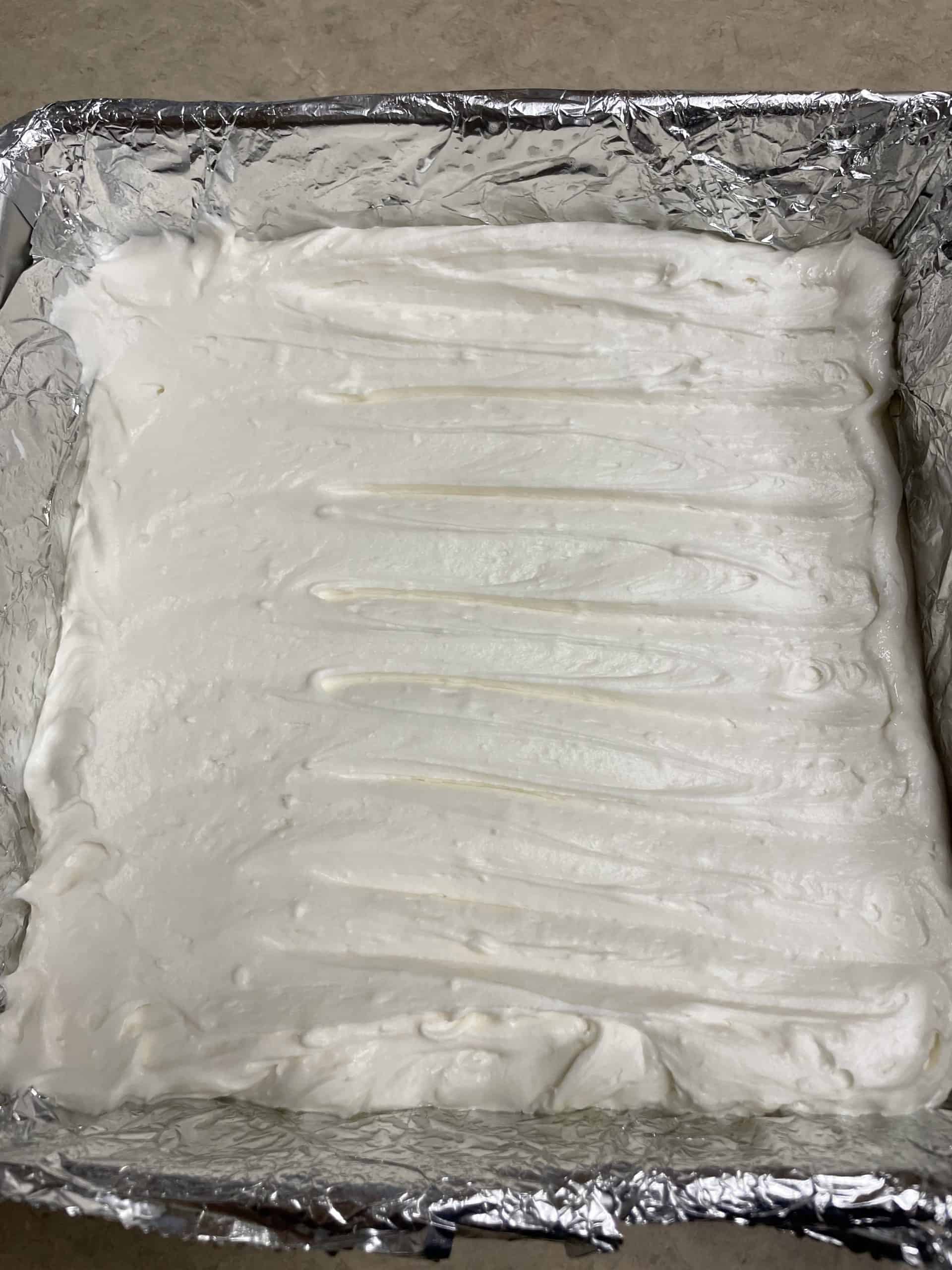 White Chocolate Fudge spread into a pan.