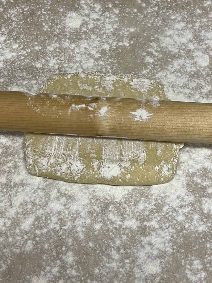 Rolling cookie dough on a floured surface.