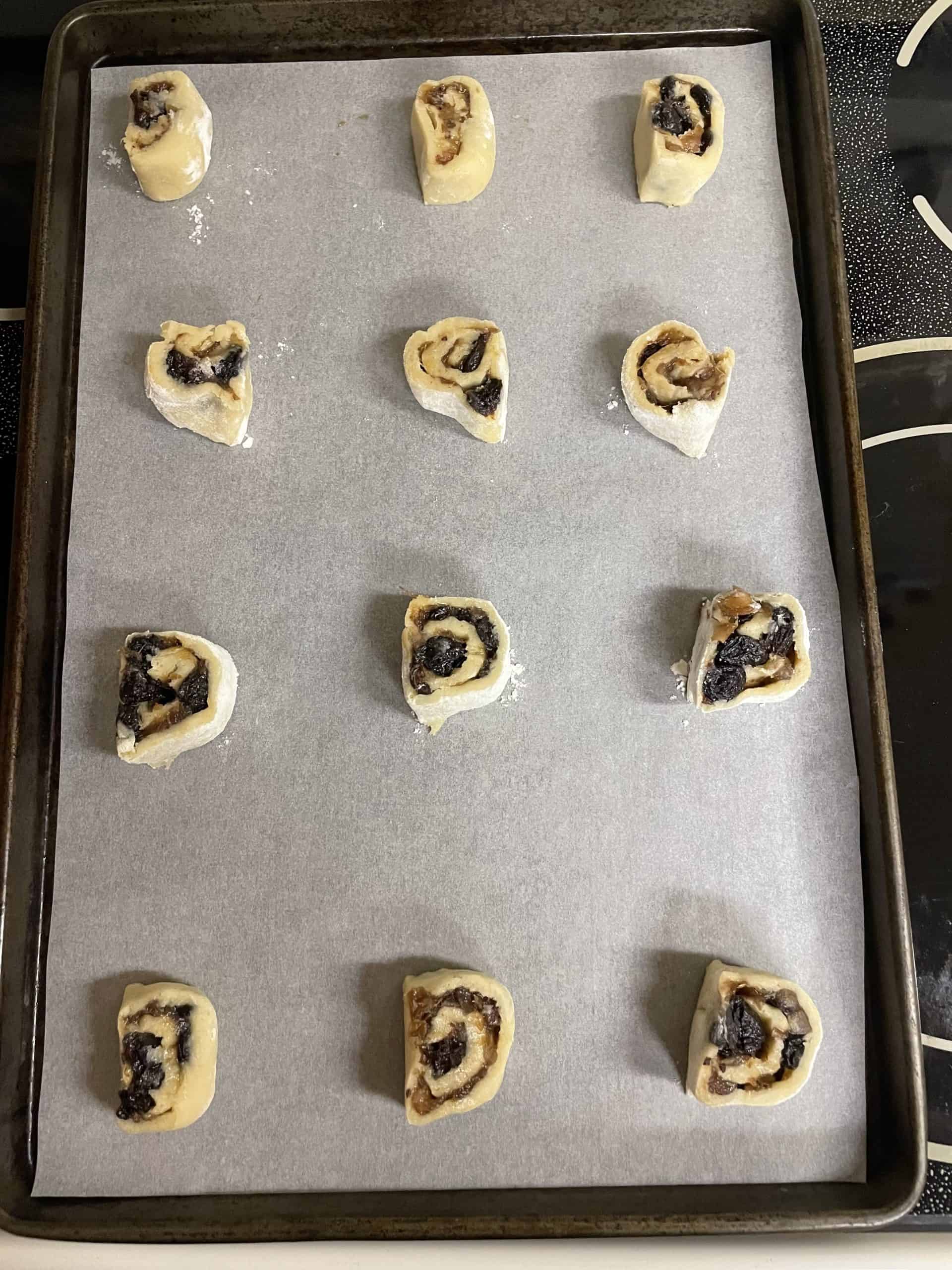 Sheet pan of filled date cookies.