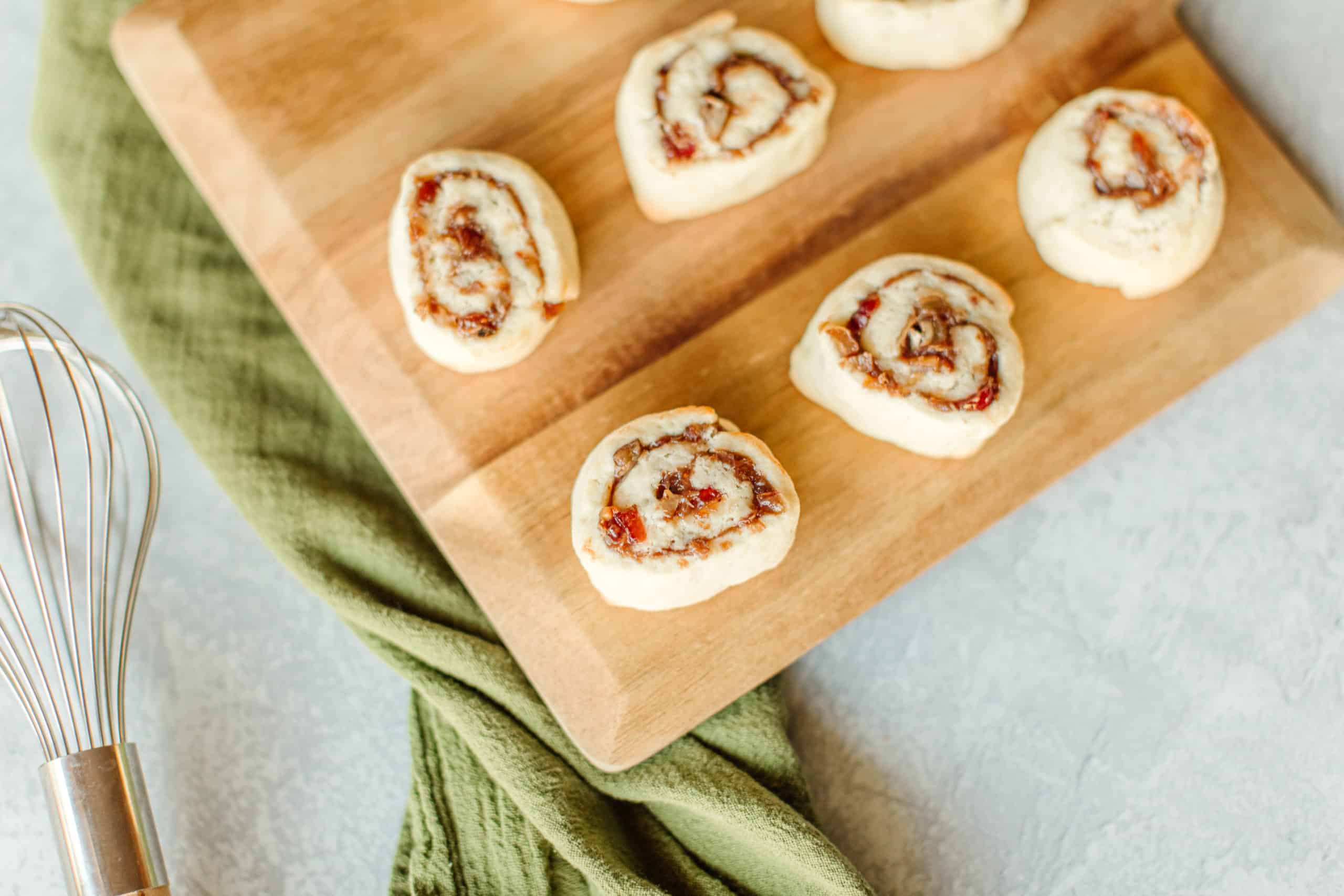 Pinwheel Cookies with Cranberries on a wooden board.