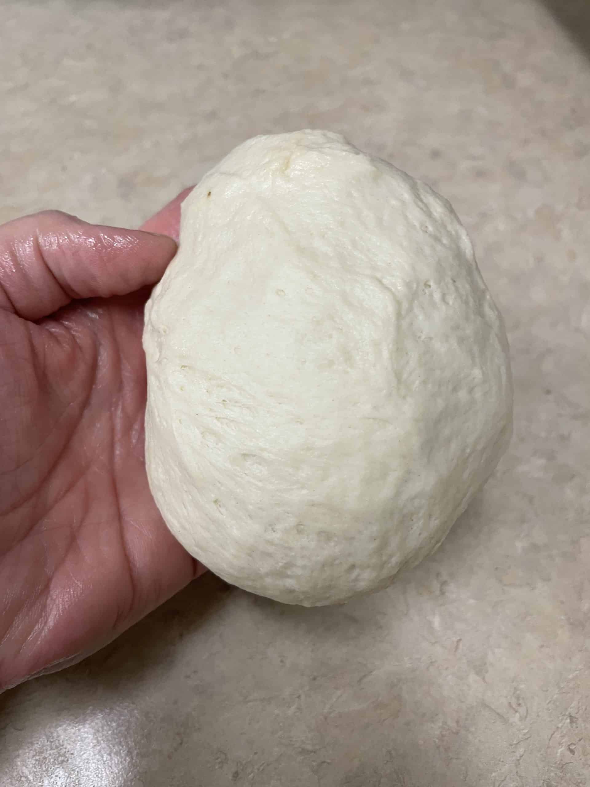 With Both Hands, Gently Fold the Dough to the Bottom Center Creating a Smooth Top.