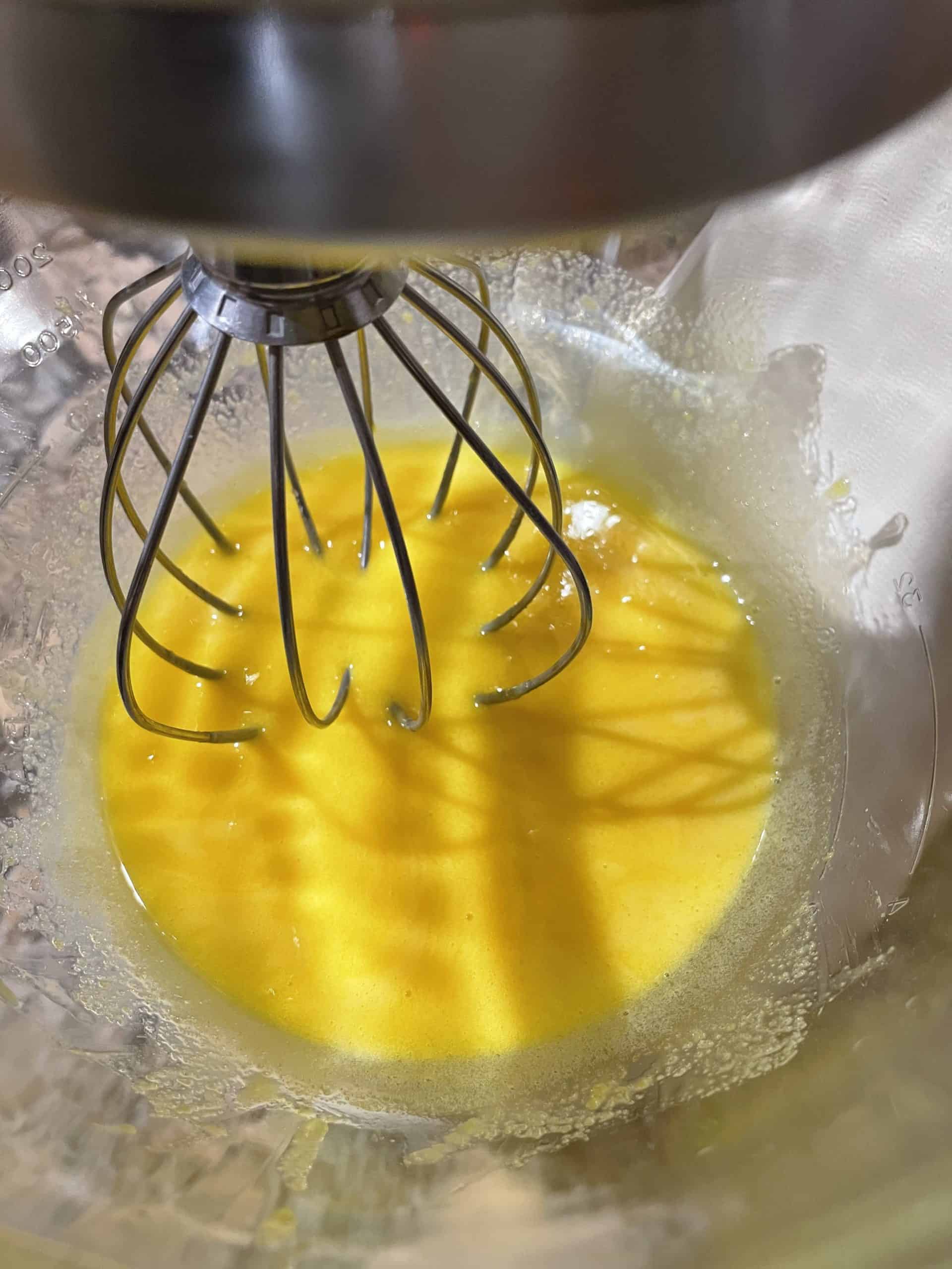 Whipped egg yolks in a mixing bowl.