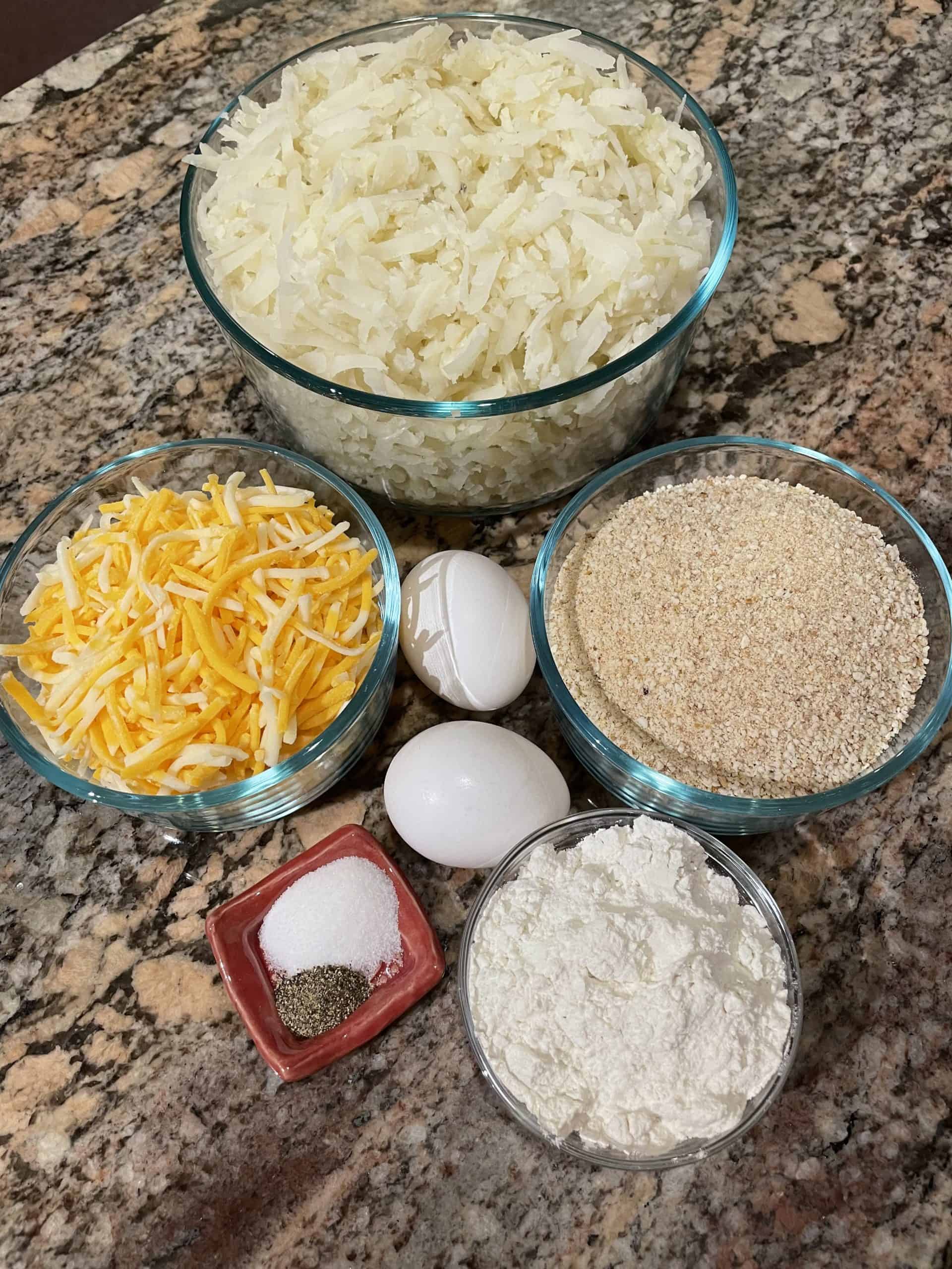 Cheesy Tater Tots Ingredients - shredded potatoes and cheese, flour, eggs, breadcrumbs, salt and pepper.