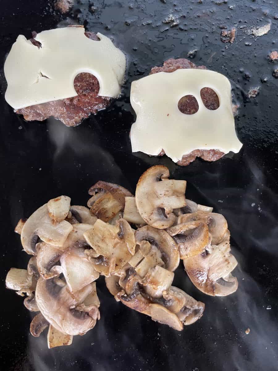 Sautéed Mushroom and Swiss Cheese Topped Smash Burger on a Blackstone Griddle.