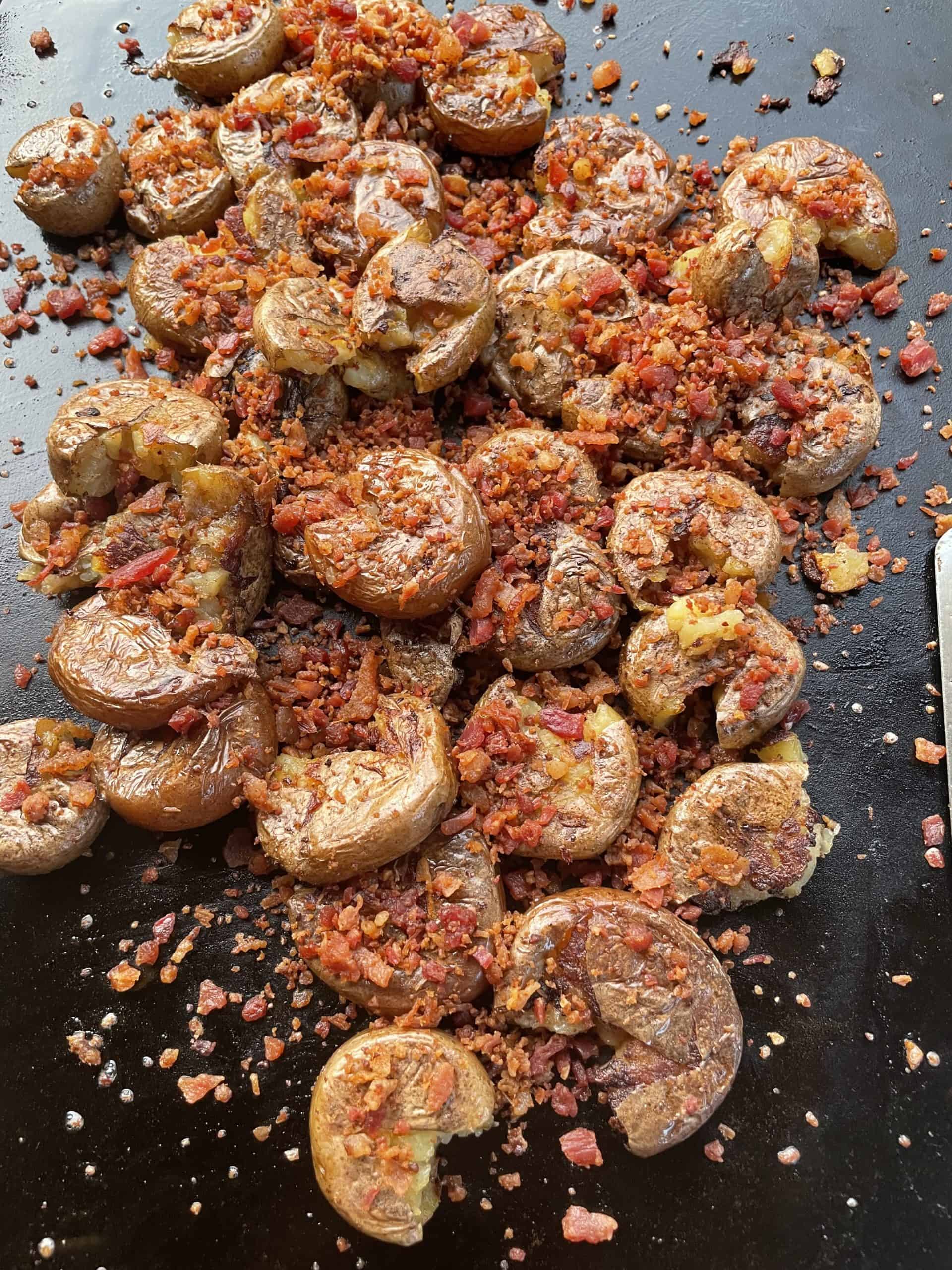 Add Bacon Pieces to the top of the crispy smashed potatoes.