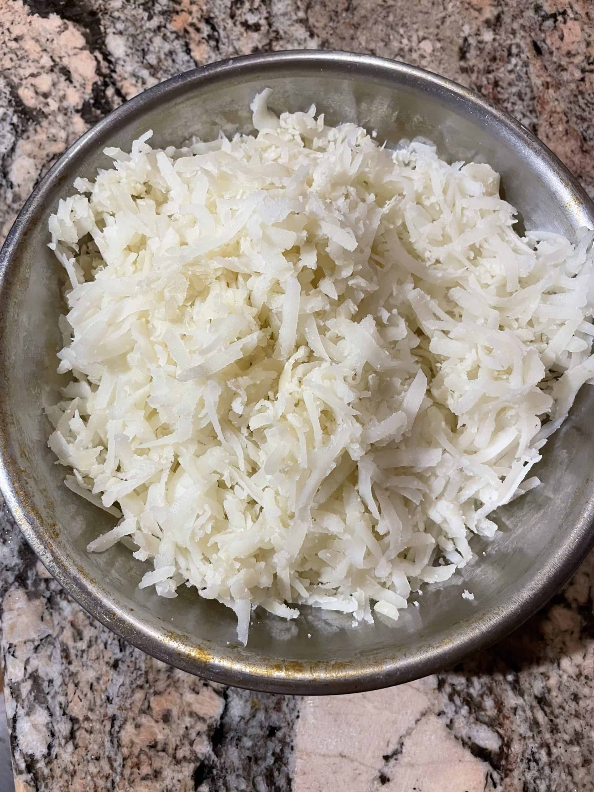 Shredded Potatoes in a Mixing Bowl.