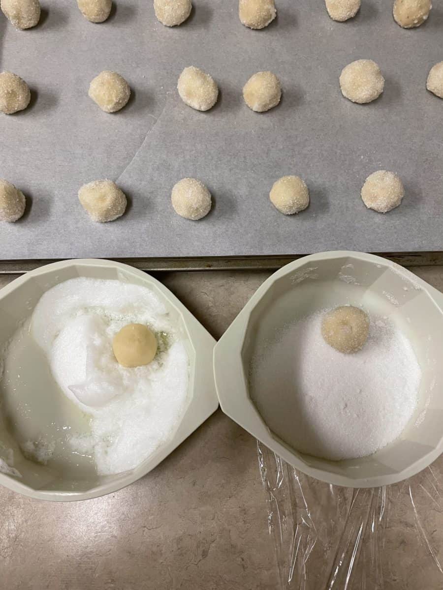 Dip the Dough Balls into the frothy egg white and then the granulated sugar and place on a baking sheet.