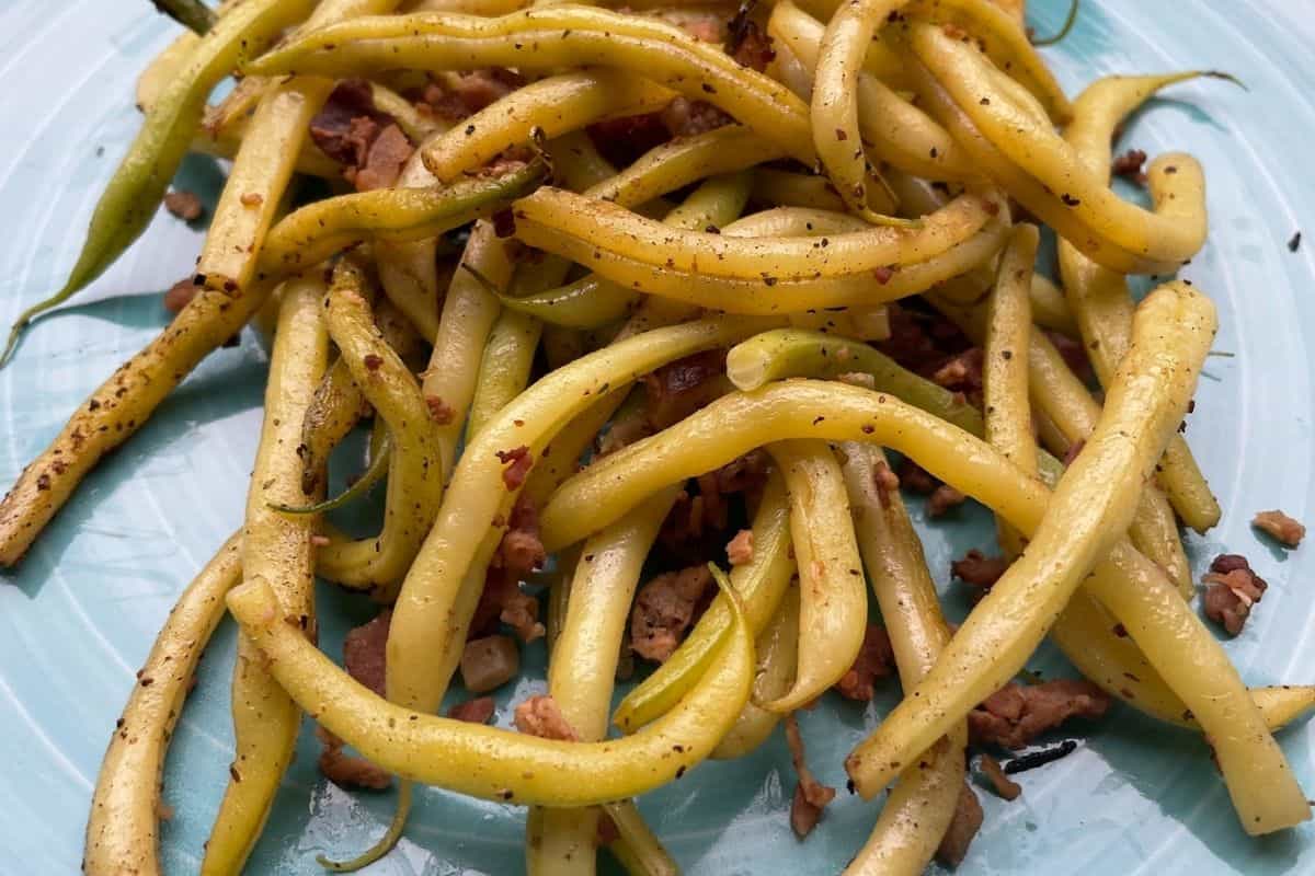 Yellow Beans Cooked on a Blackstone Griddle then placed on a teal colored serving plate.