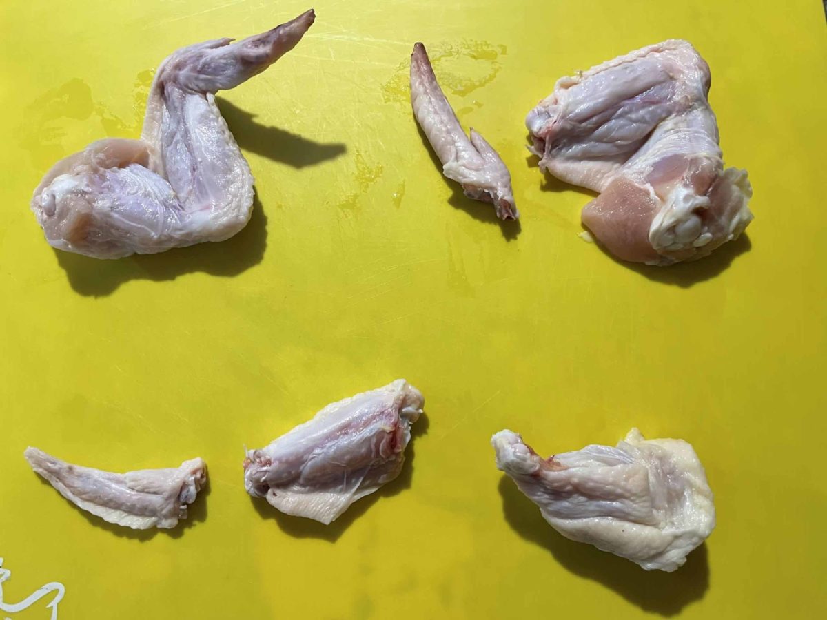 How to cut a whole chicken wing: cut the tip off, then cut the drumette off the flat piece.