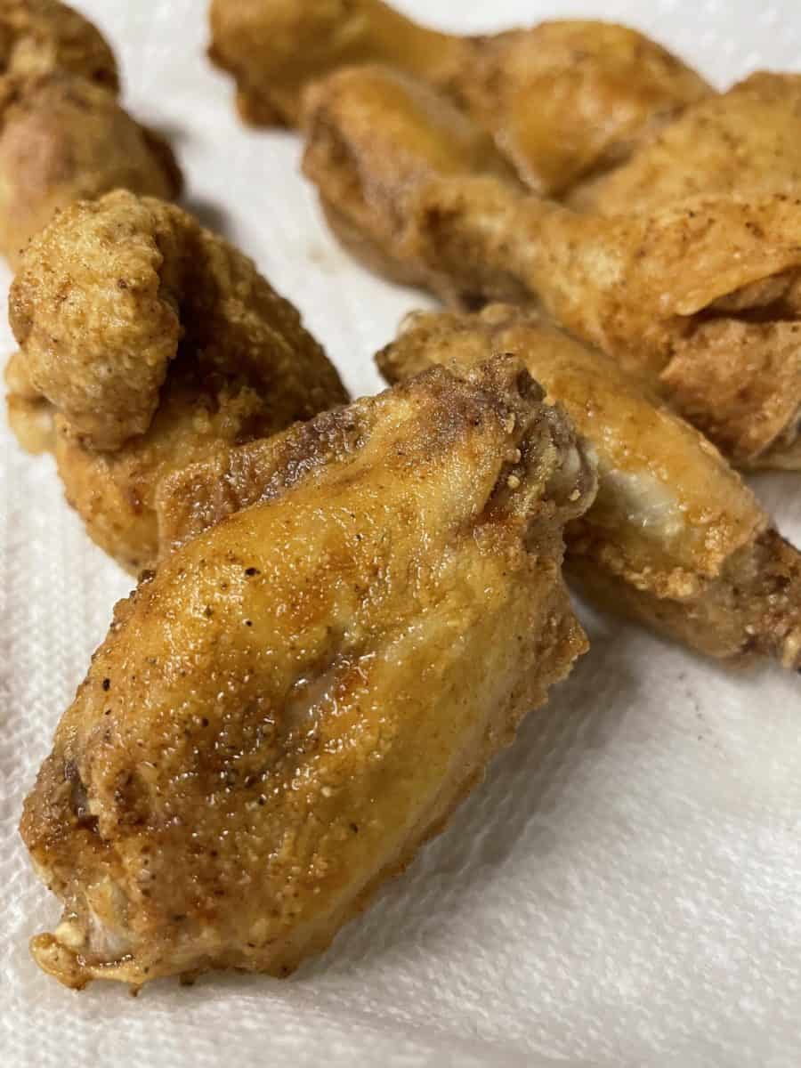 Fried Blackstone Wings on a Paper Towel Lined Plate.