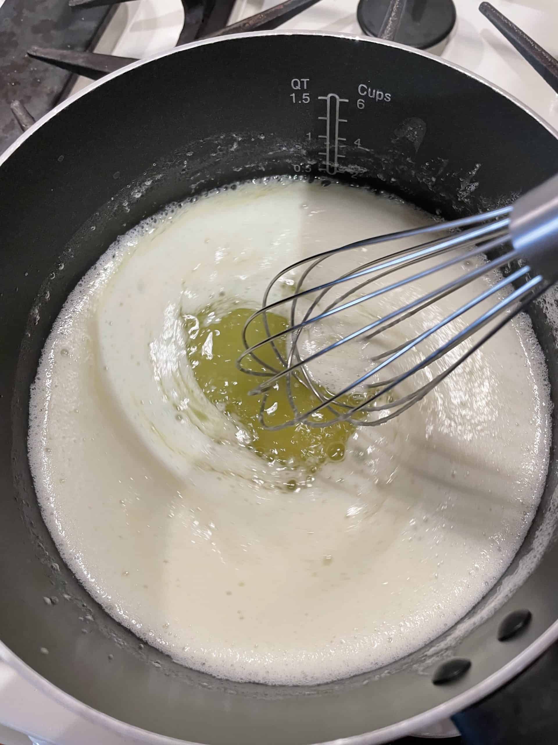 Melting butter in a pan with a whisk.