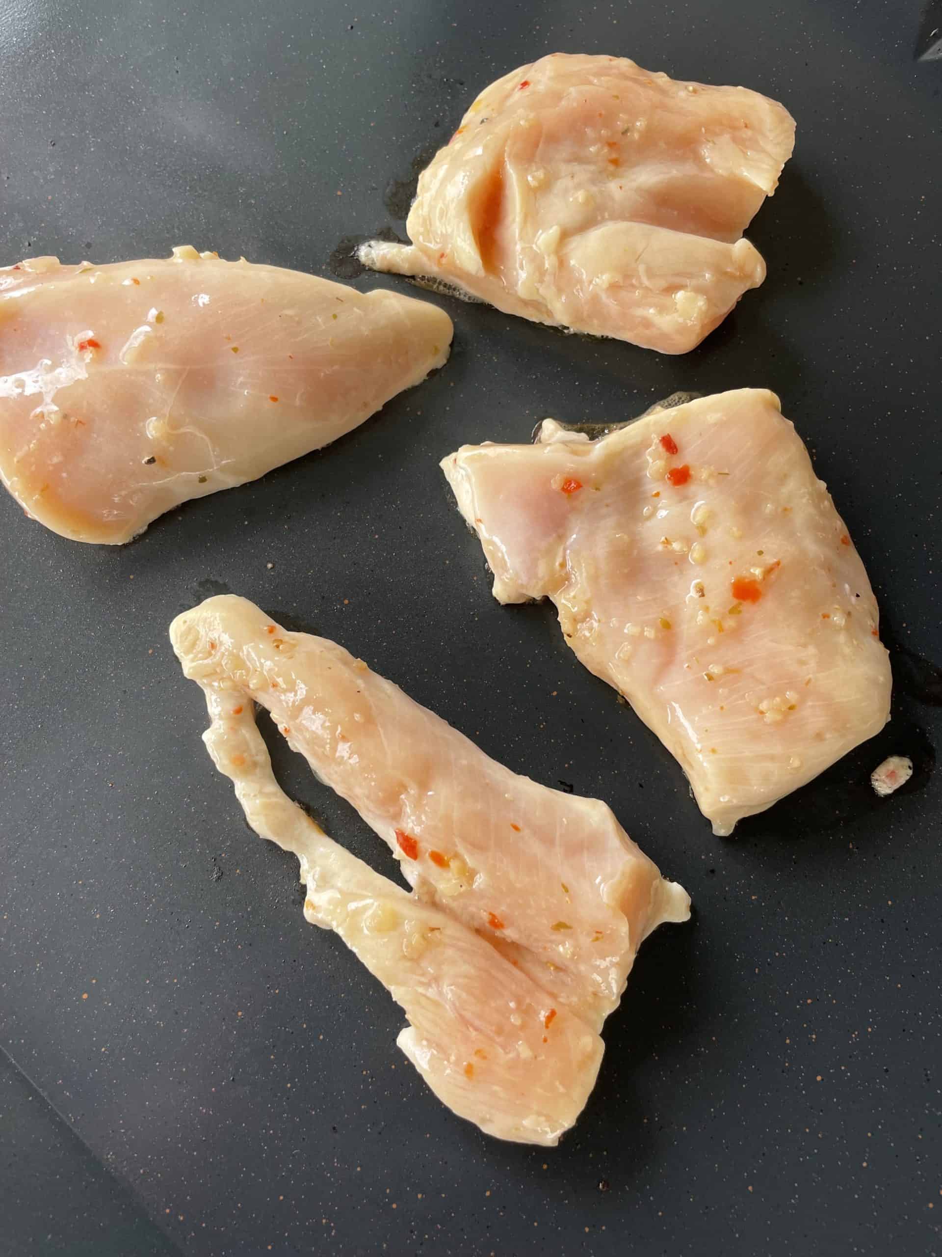 Marinated Chicken Breast pieces on a Blackstone Electric Griddle.