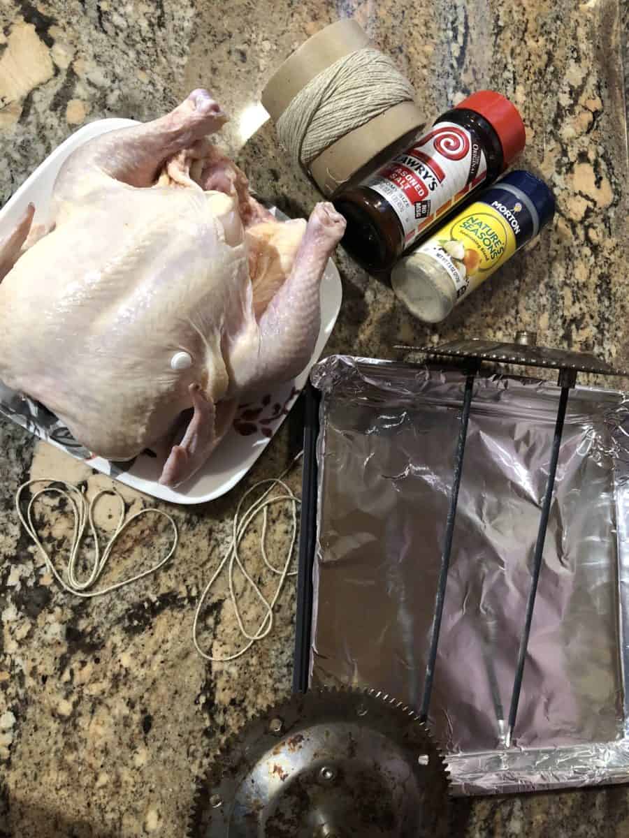 Rotisserie Chicken Ingredients:  Whole Chicken, Sheet of Foil, Lawry's Salt, Morton's Natures Seasonings, Kitchen String, and Oven Parts