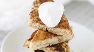 Grilled Fluffernutter stacked up on a plate and topped with marshmallow fluff.