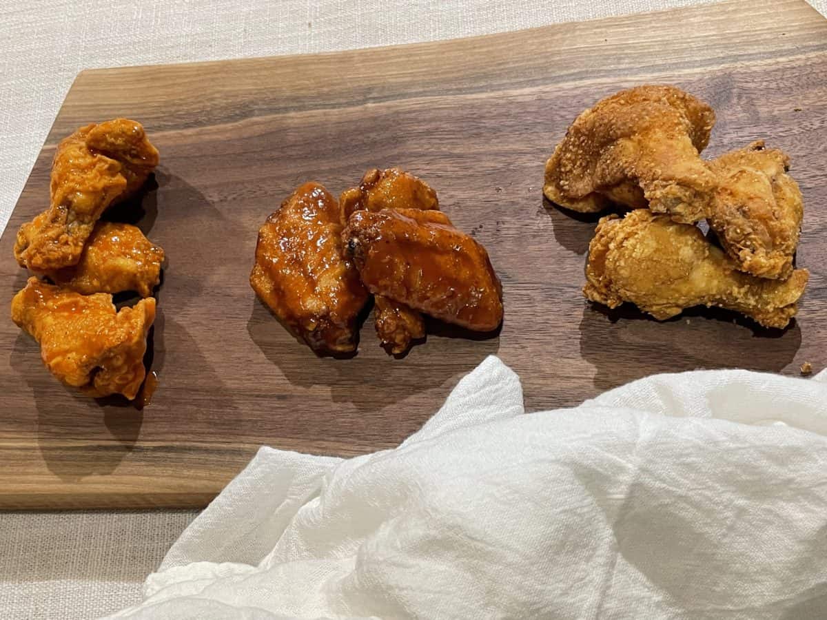 A Trio of Chicken Wings: Buffalo, BBQ and Plain Deep Fried Wings on a wooden board.