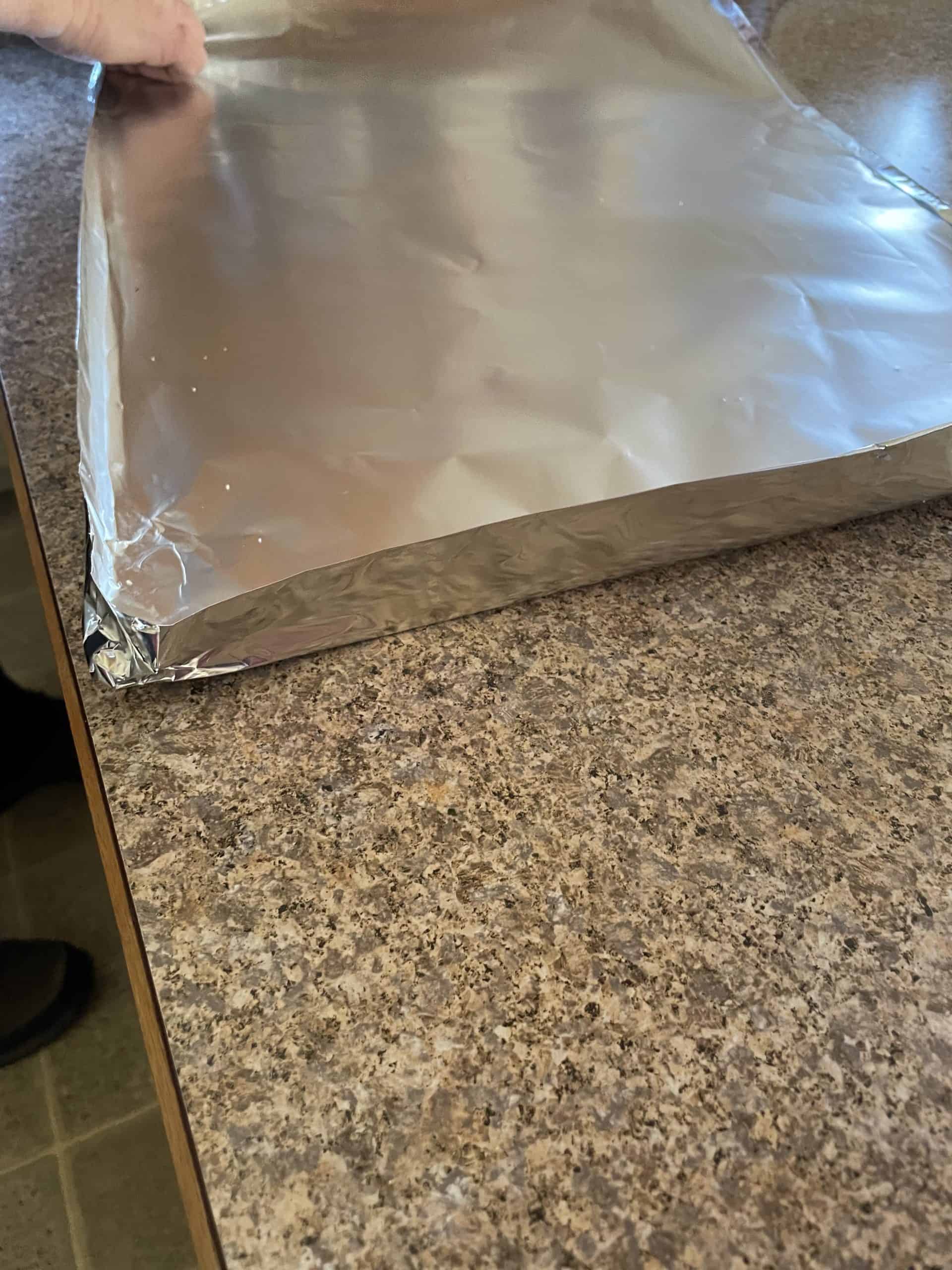 Crimp the corners together to form a foil tray.