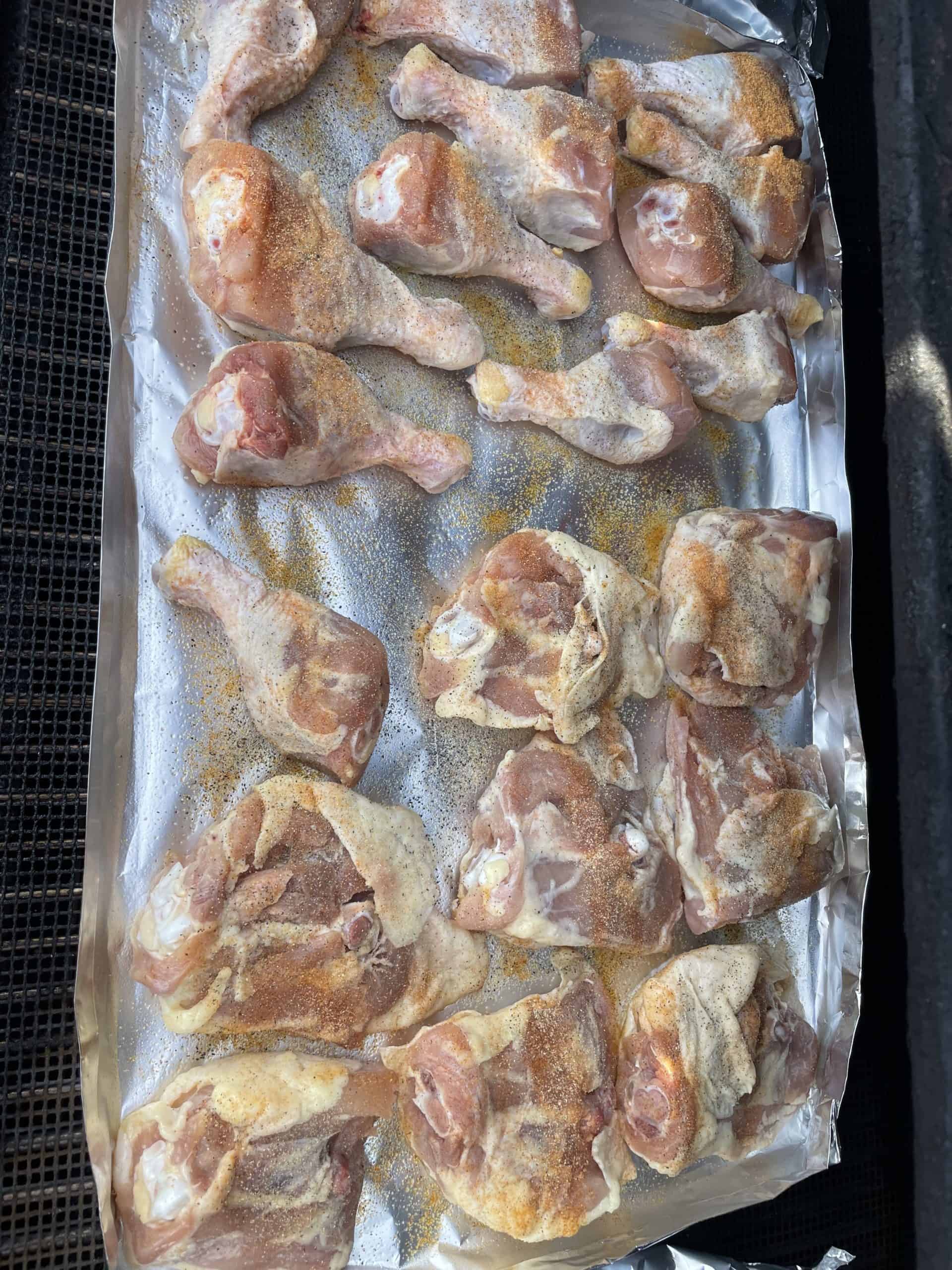 Place seasoned chicken pieces onto greased foil skin side down while on the pellet smoker grill.