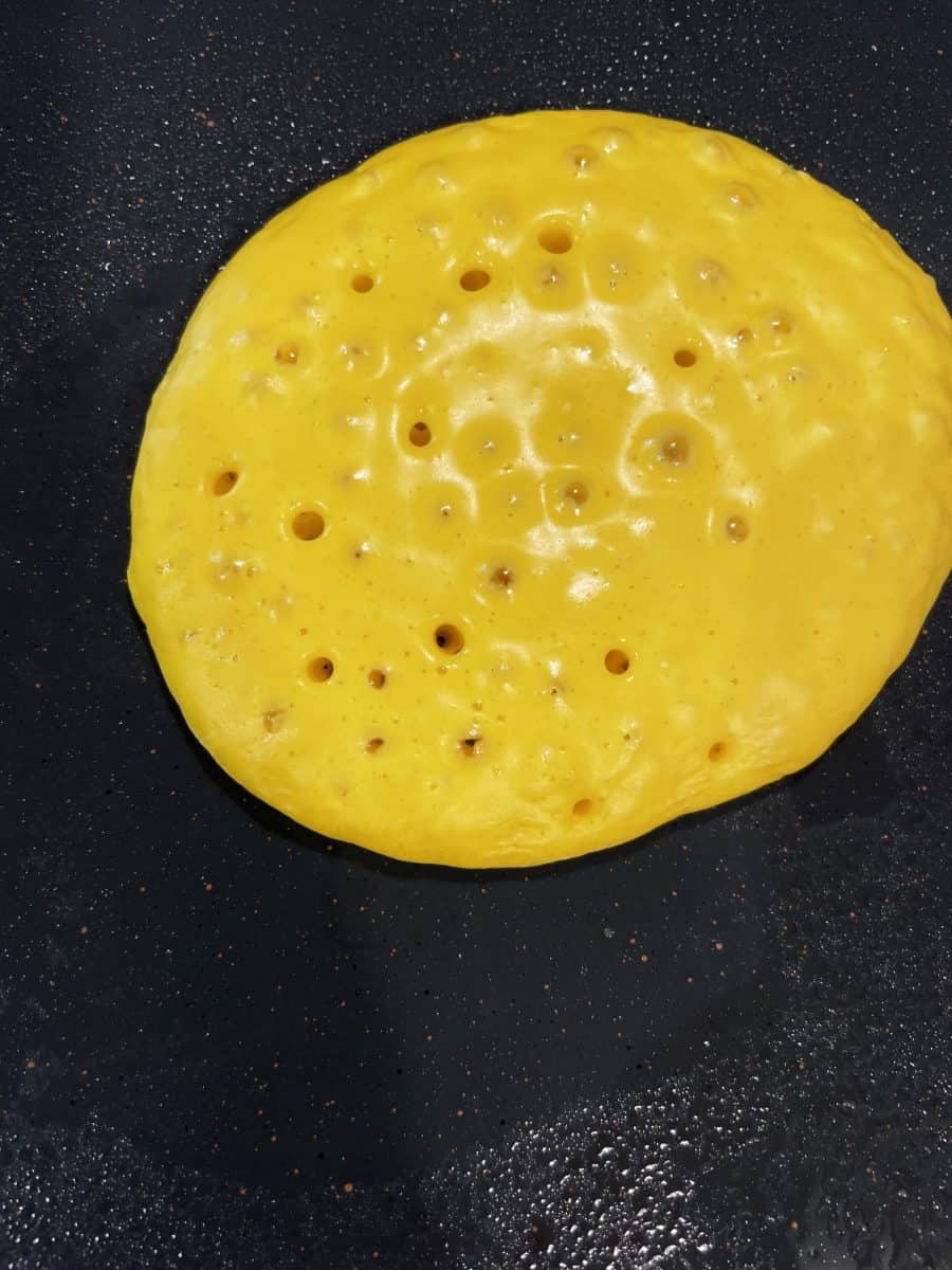 A Cooking Colored Pancake with Bubbles.