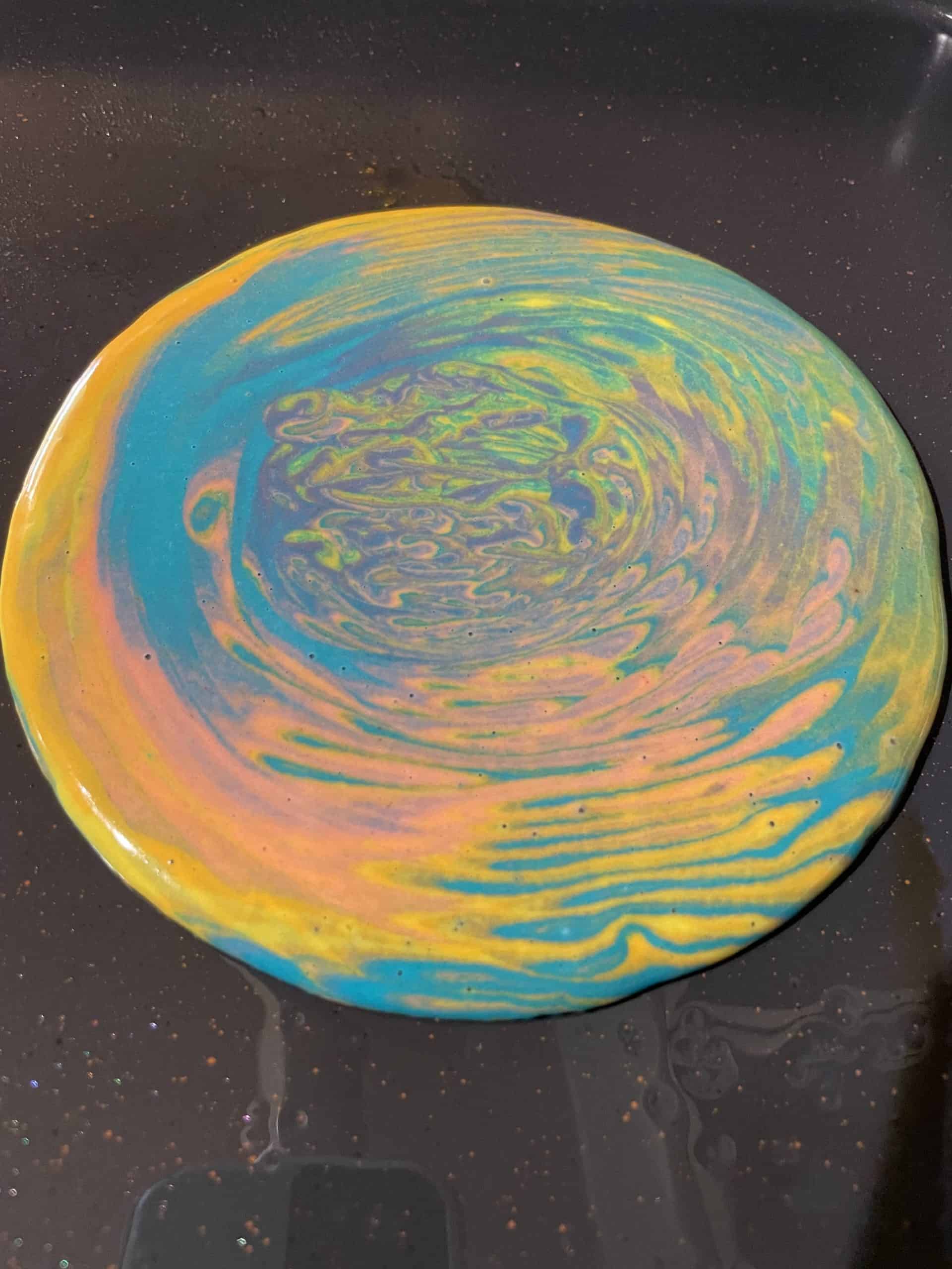 Tie Dyed Pancake Batter cooking on a griddle.