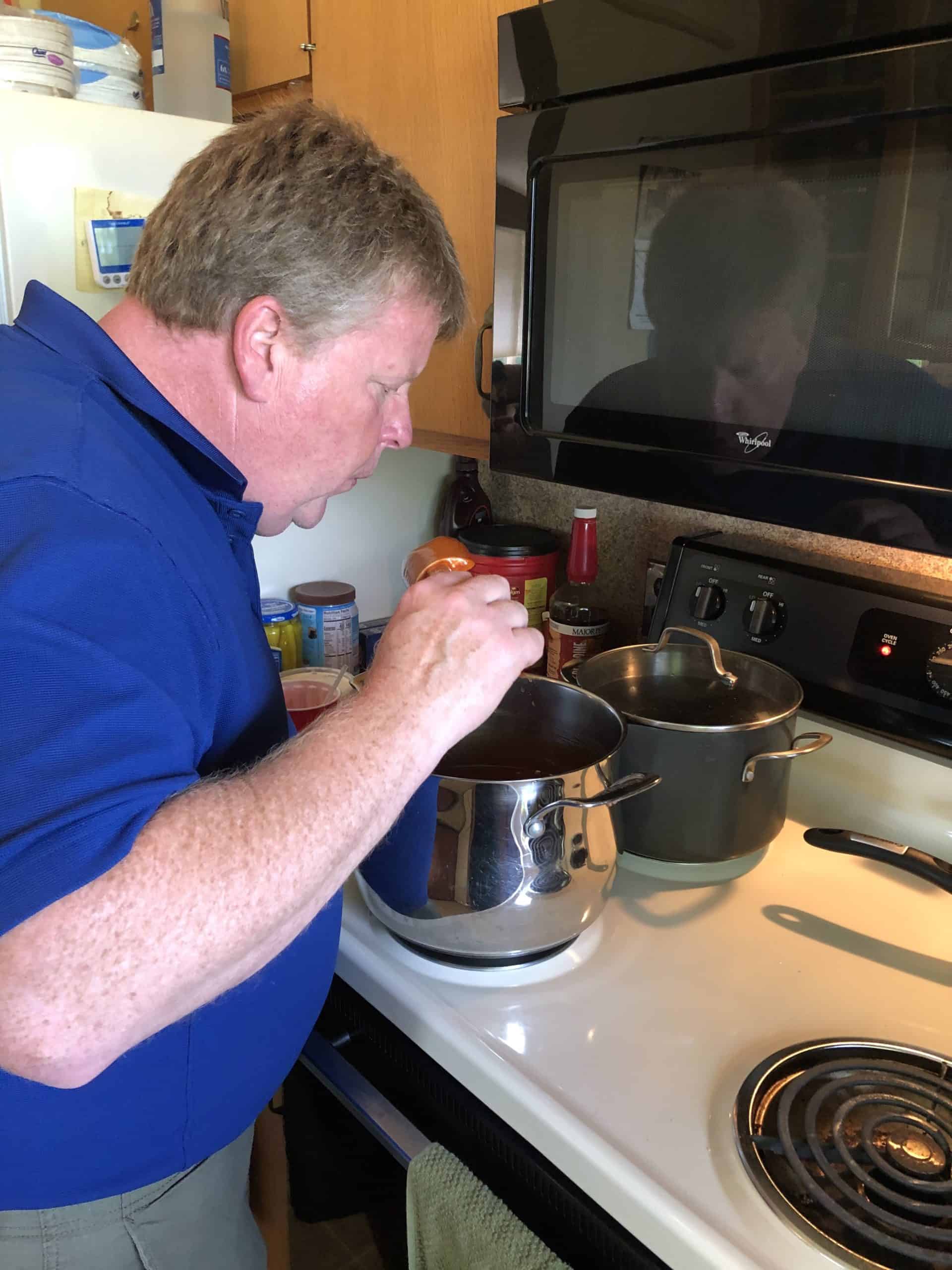 Joel Mackey testing his Famous BBQ Sauce cooking on the stove.