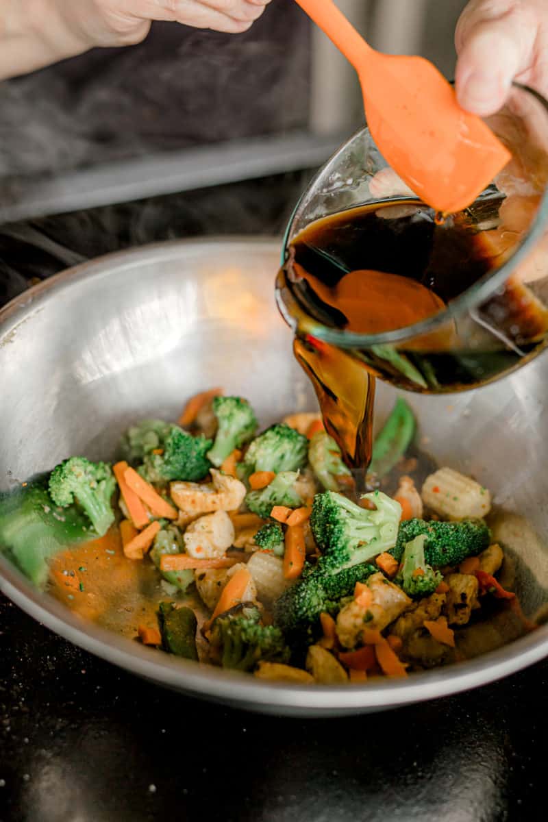 Pouring the Stir Fry Liquid into the Cooked Vegetables and Chicken Pieces.