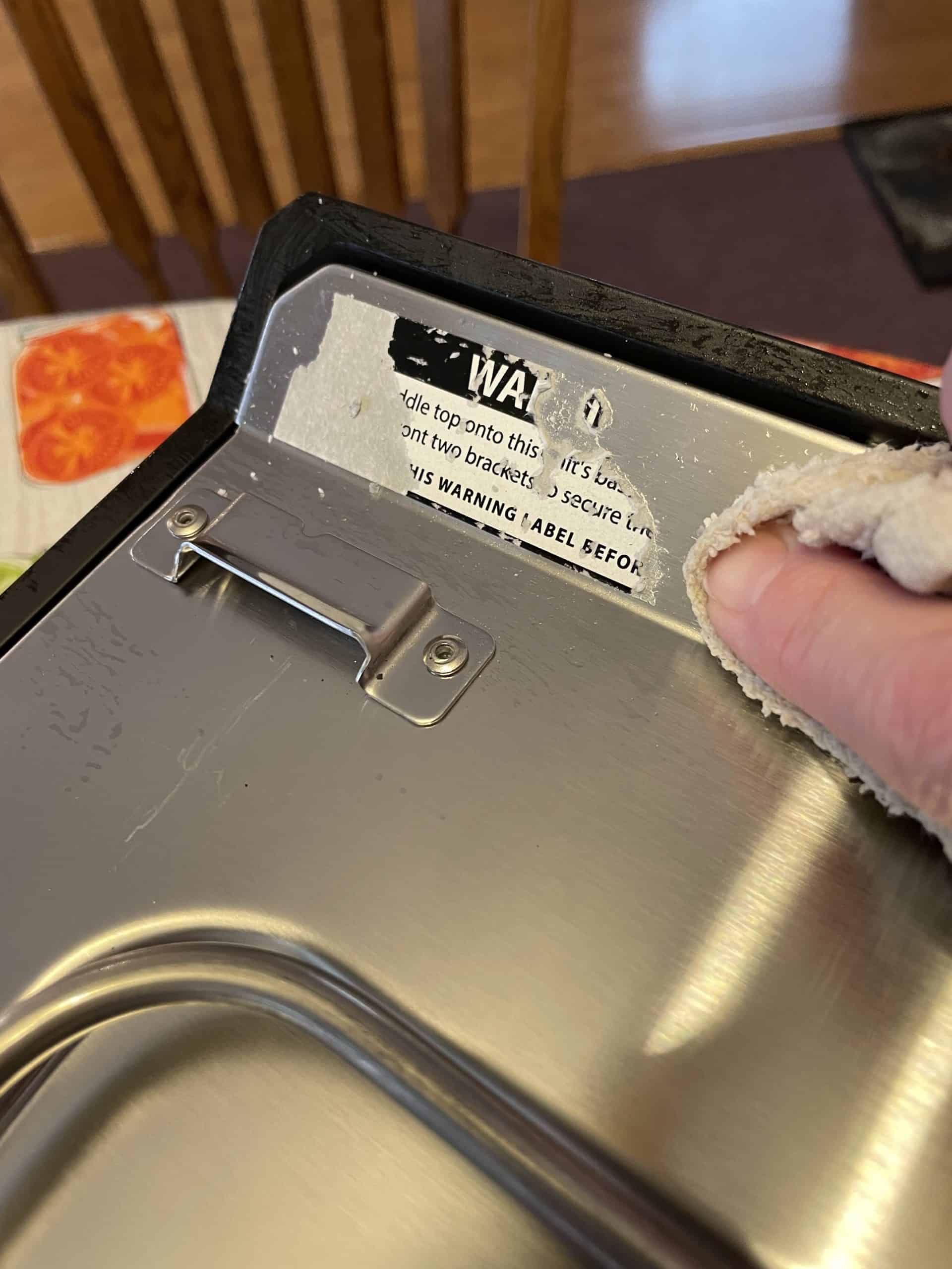 Remove the warning sticker before placing the flat top griddle onto the base.