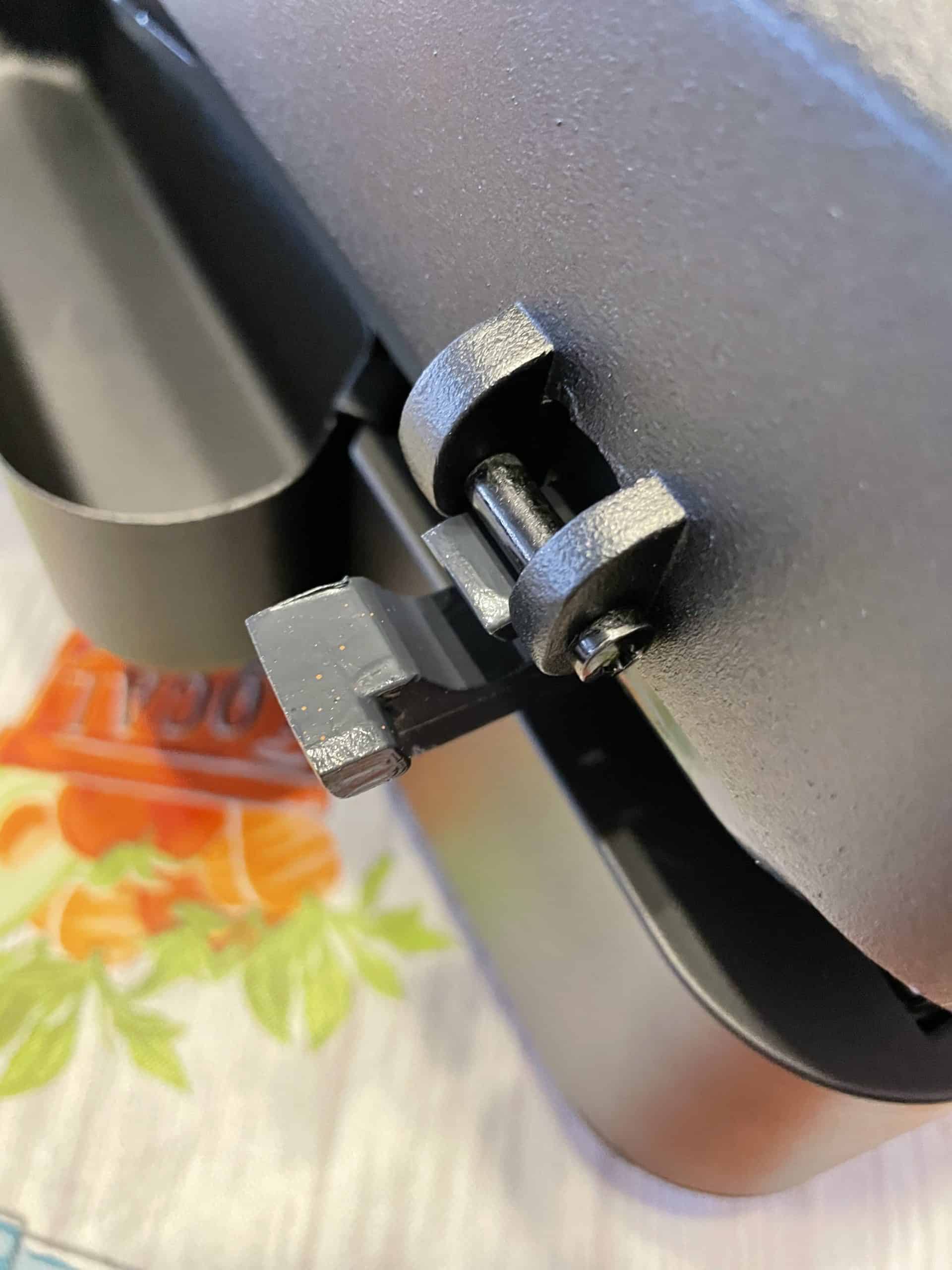 Attach the hood lid hinge into the base bracket of the tabletop grill electric.